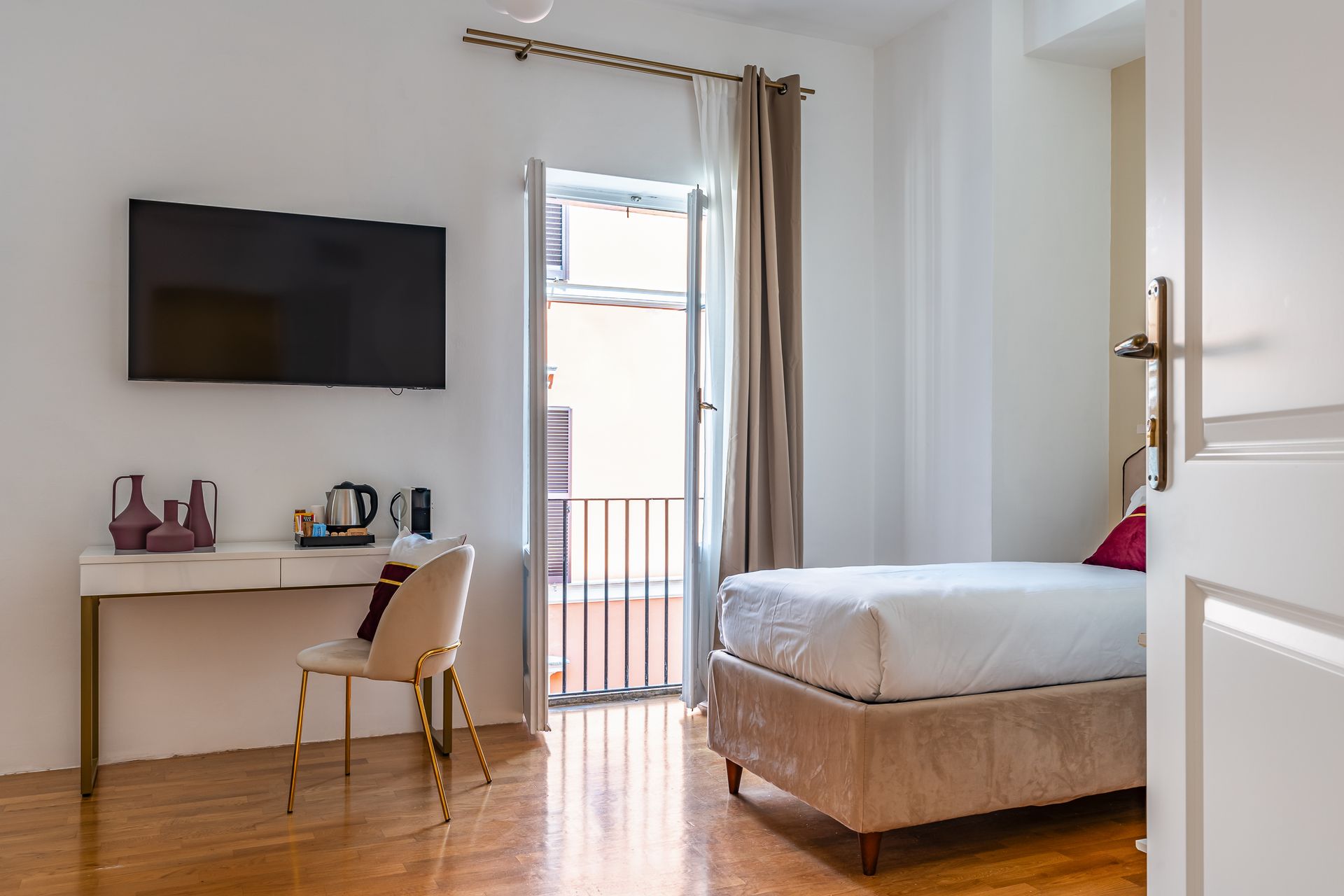 A bedroom with a bed , desk , chair and television.