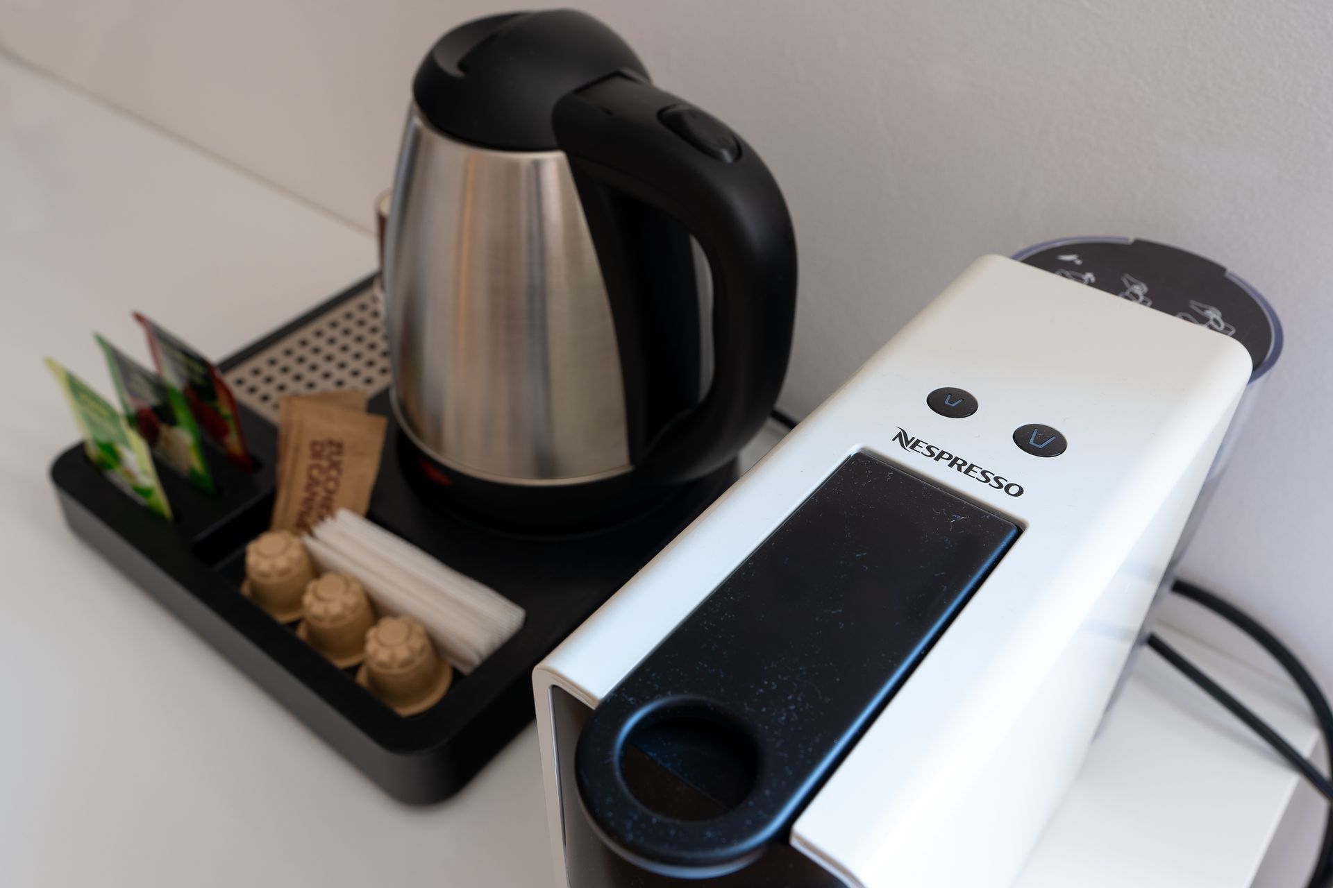 A kettle and a coffee maker are on a table