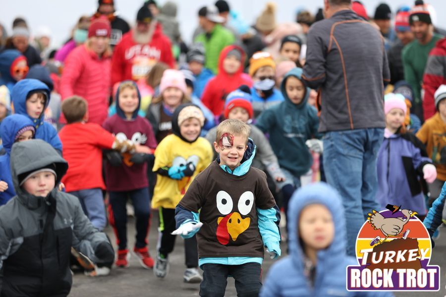 A group of children are running in the Castle Rock turkey rock trot