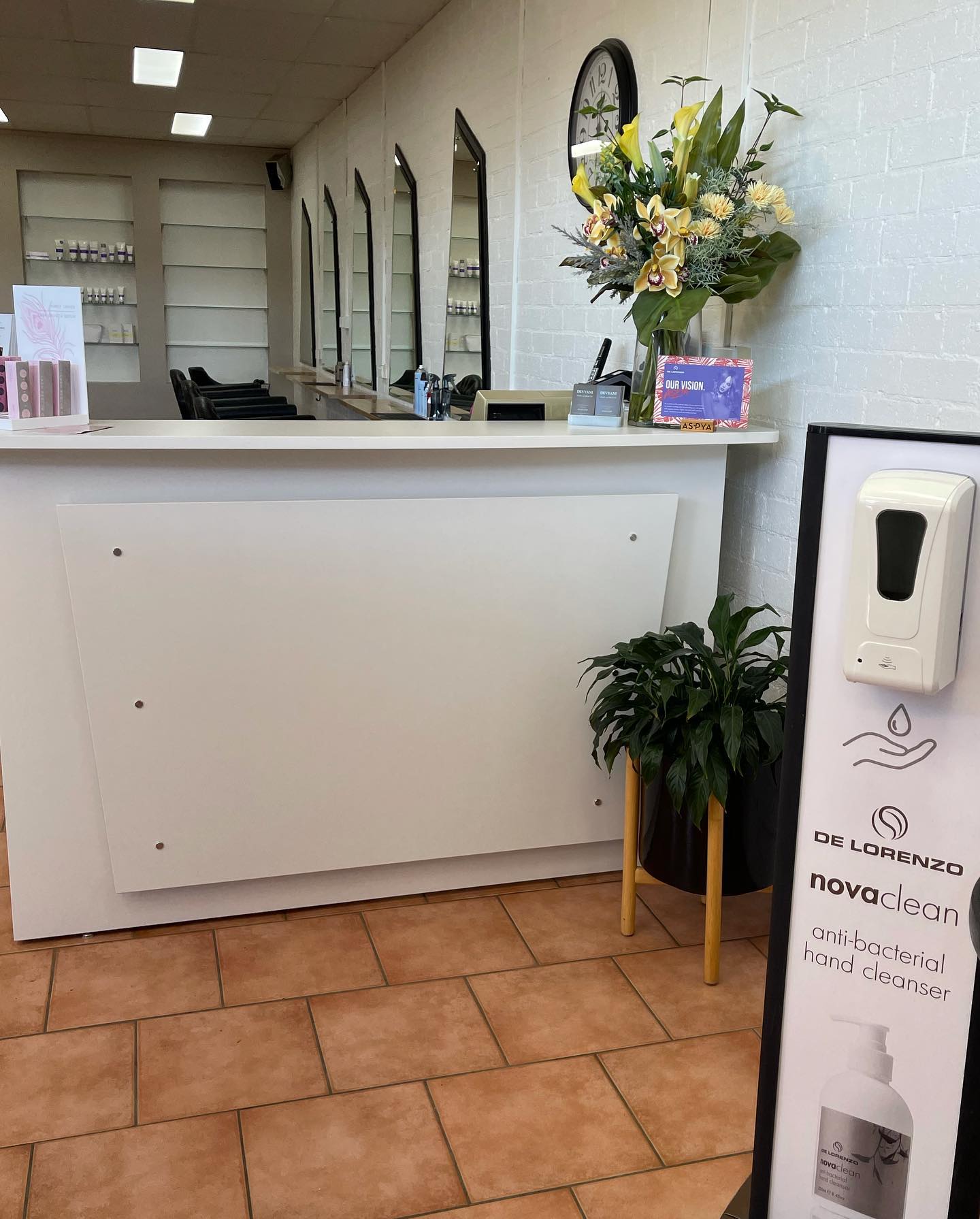 Female Barber Combing Woman's Hair At A Hair Salon - Hair And Beauty In Unanderra, NSW