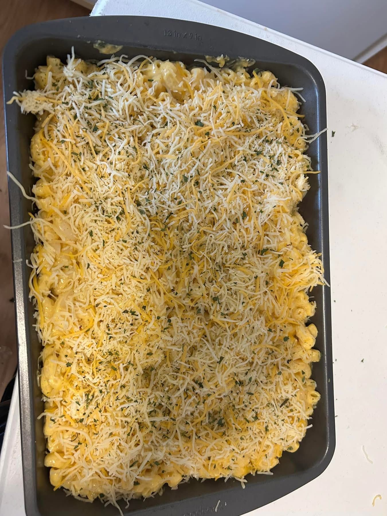 A pan of macaroni and cheese is sitting on a table.
