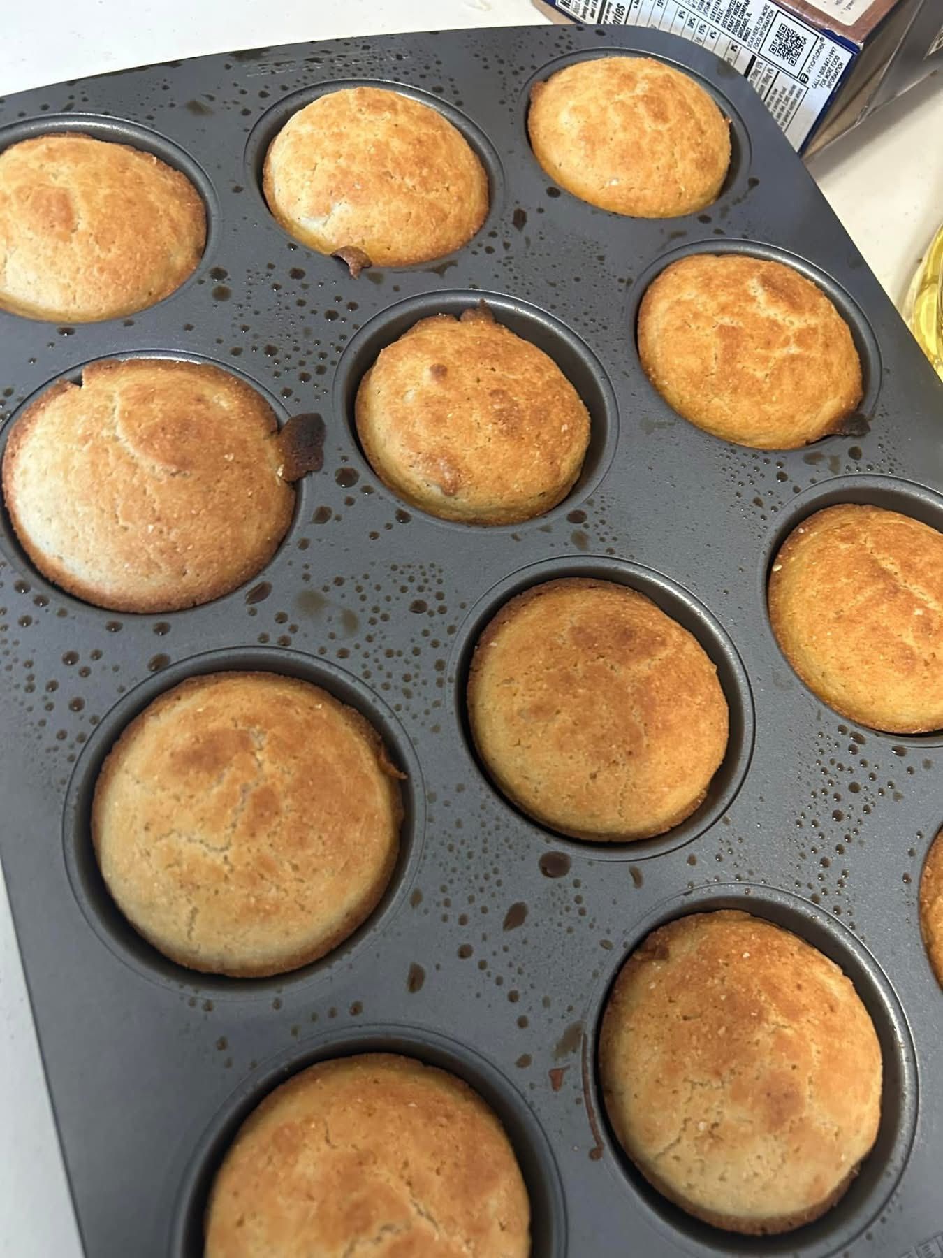 A muffin pan filled with muffins is sitting on a table.