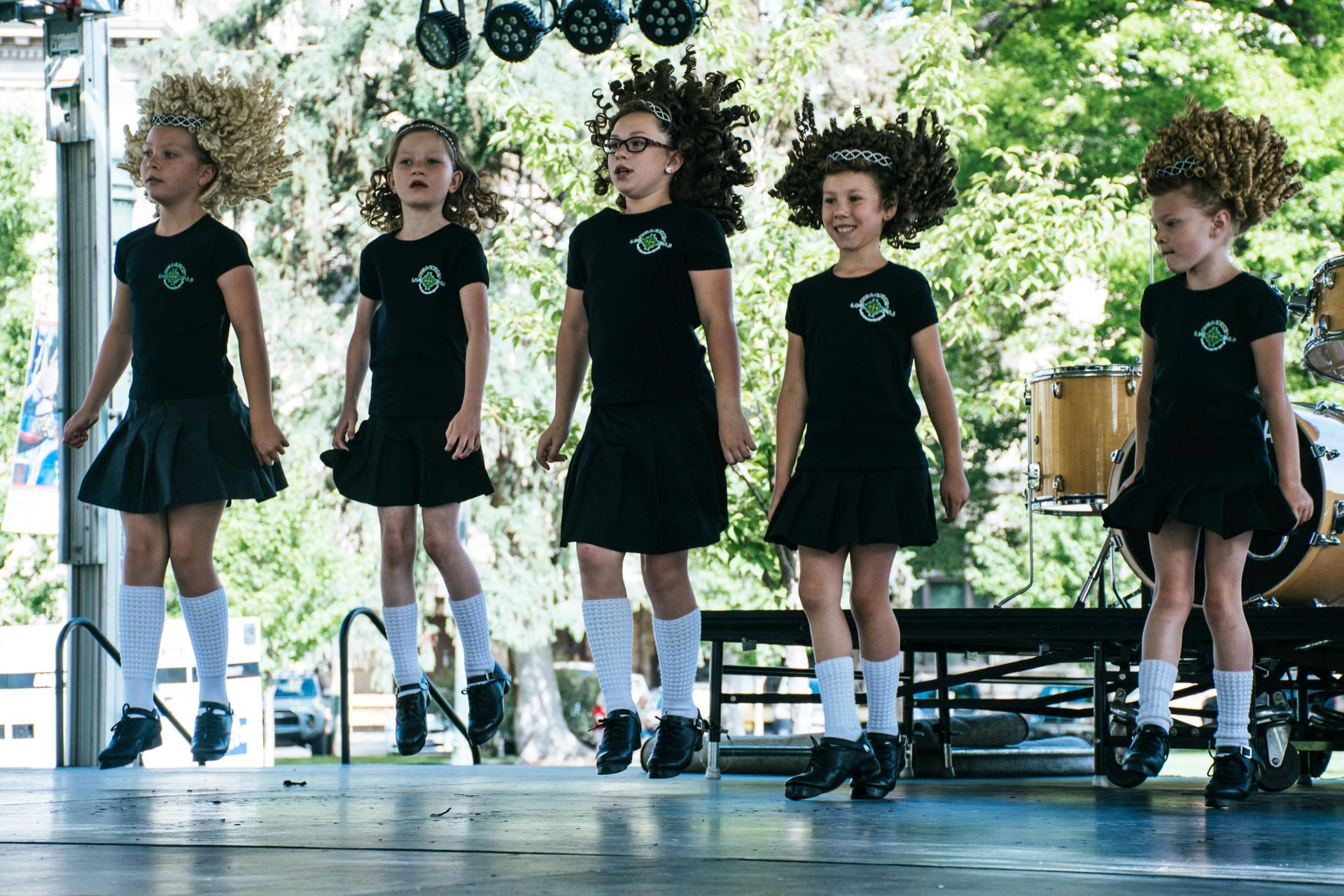 A group of young girls are dancing on a stage.