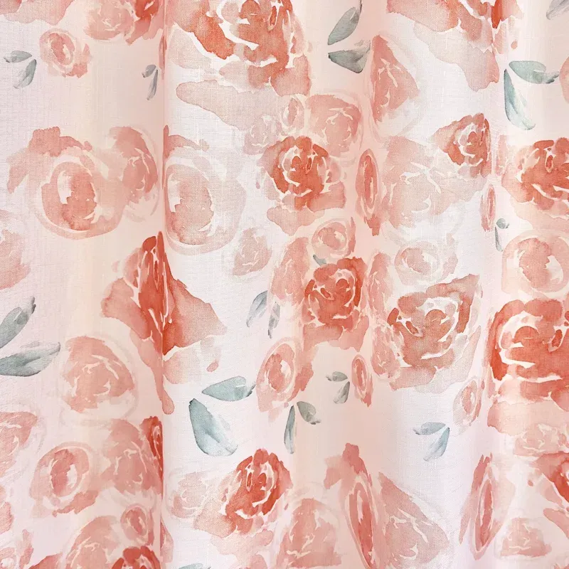 A close up of a shower curtain with a floral pattern on it.