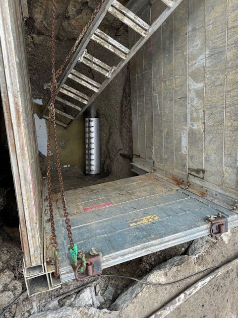 A ladder is hanging from the side of a building.