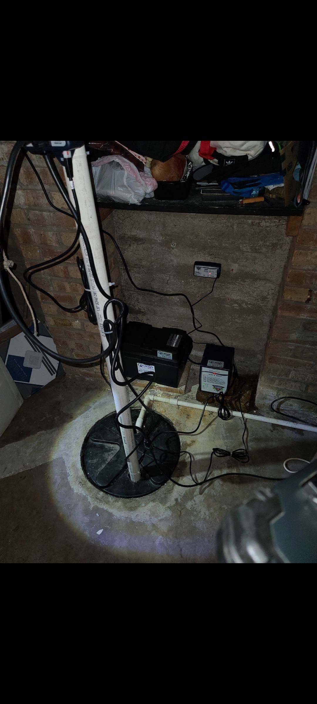 A sump pump is sitting in a basement next to a bicycle.