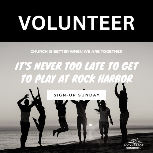 A group of people are jumping in the air on a beach.