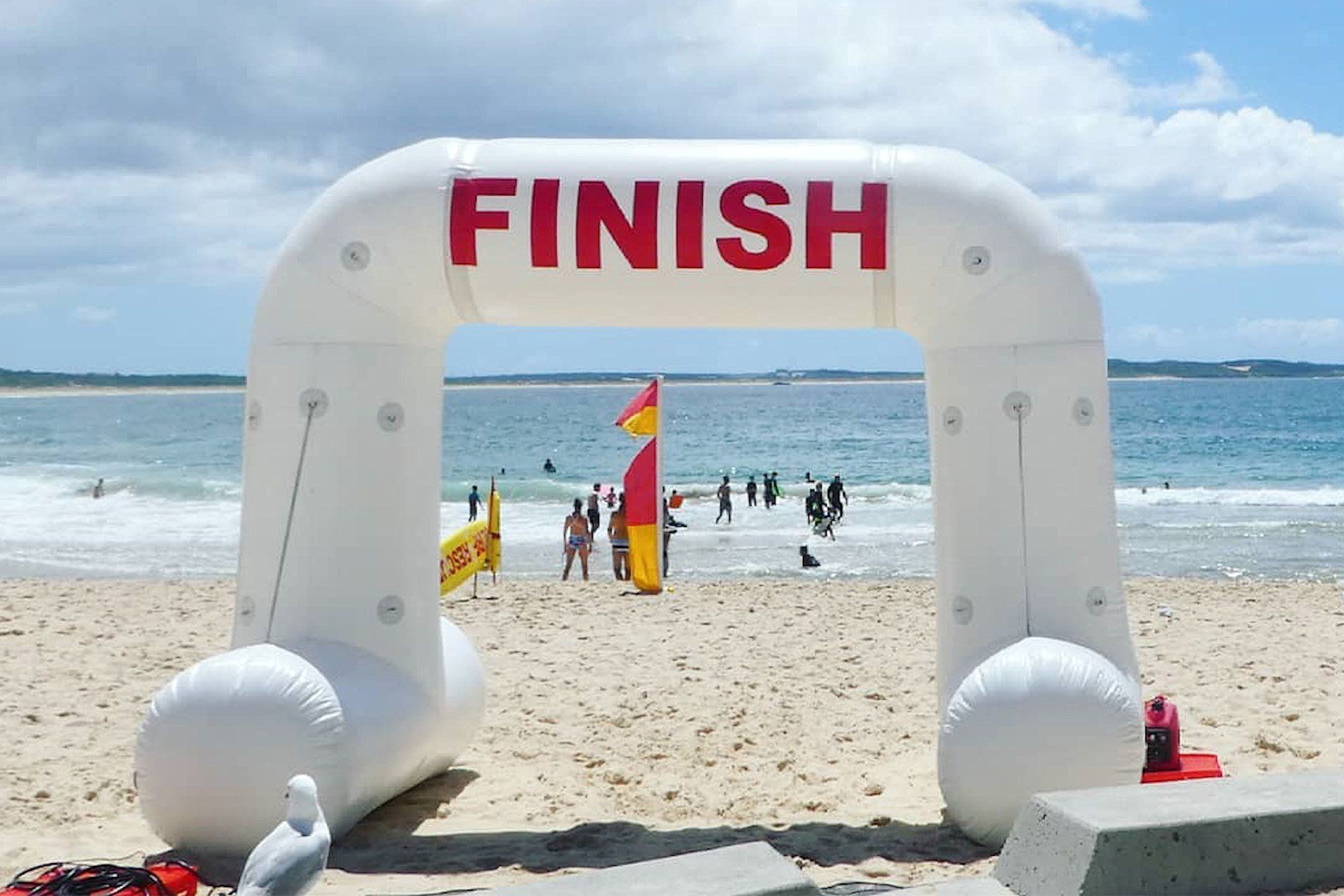 A white inflatable arch with the word finish on it