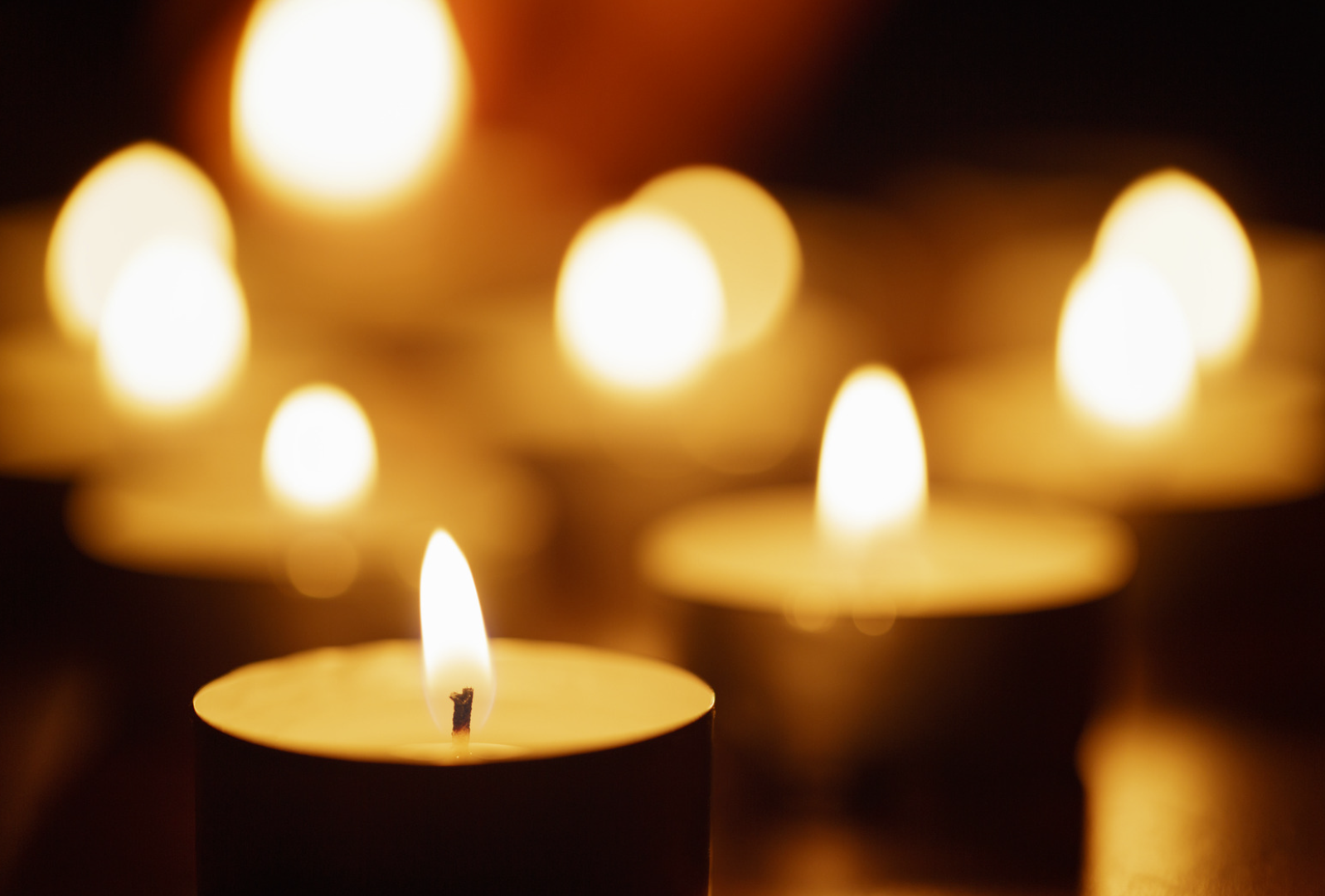 Several lit tea candle lights