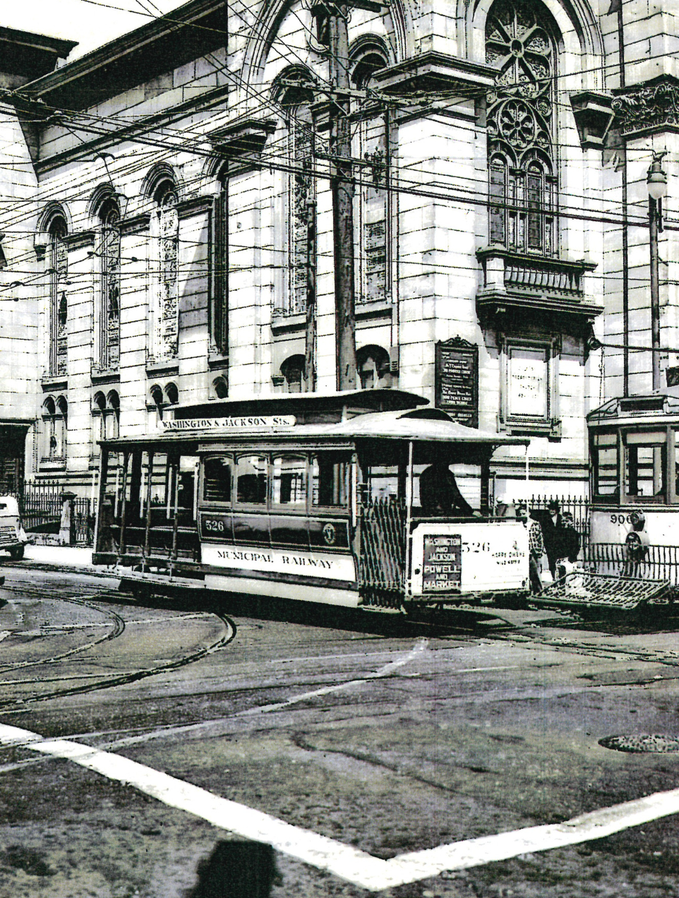 A black and white photo of a trolley car passing the front of Calvary's building on Fillmore/Jackson
