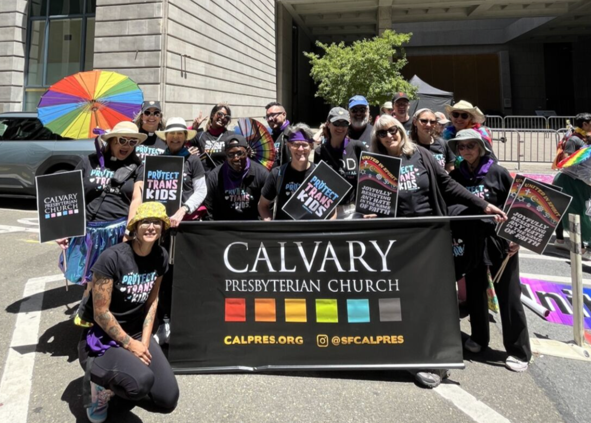 A group of Calvary goers at the SF Pride Parade standing behind a banner that says Calvary Presbyterian Church