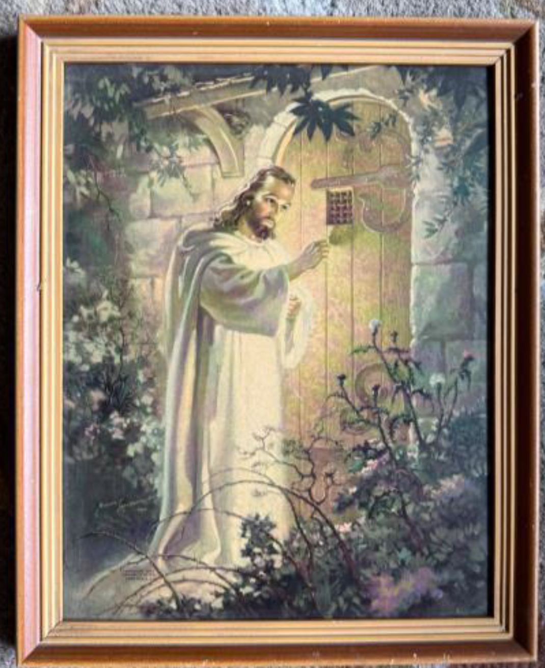 An image of Jesus with a white glow around him standing outside knocking on a wooden door