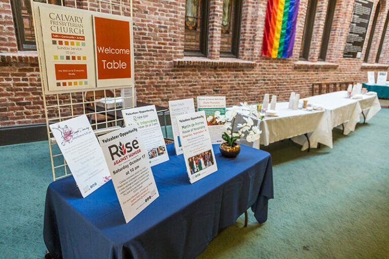 A table in the Atrium with a lot of signage for volunteer service opportunities