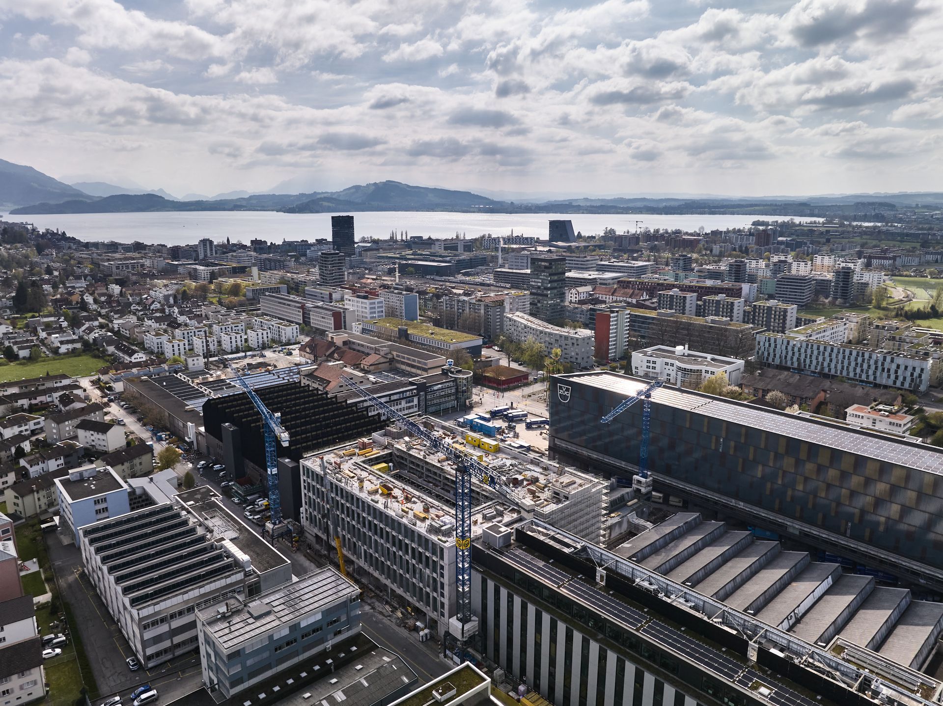 An aerial view of a city with a lake in the background.