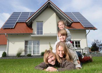 Solar Power — Family In Front Of Their House With Solar Panel in Hamburg, NY