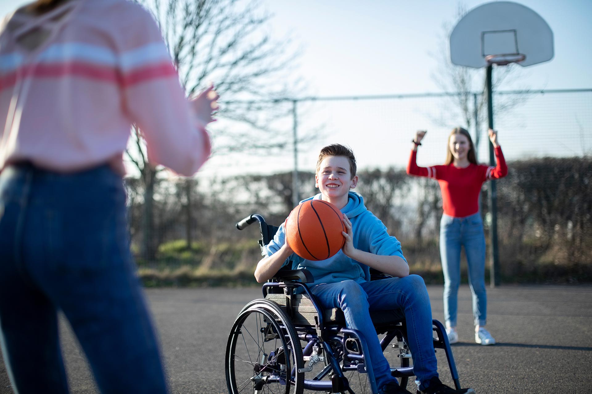 disabled boy playing basketball
