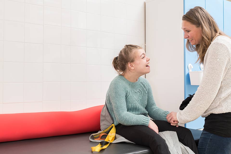 woman talking to a disabled girl