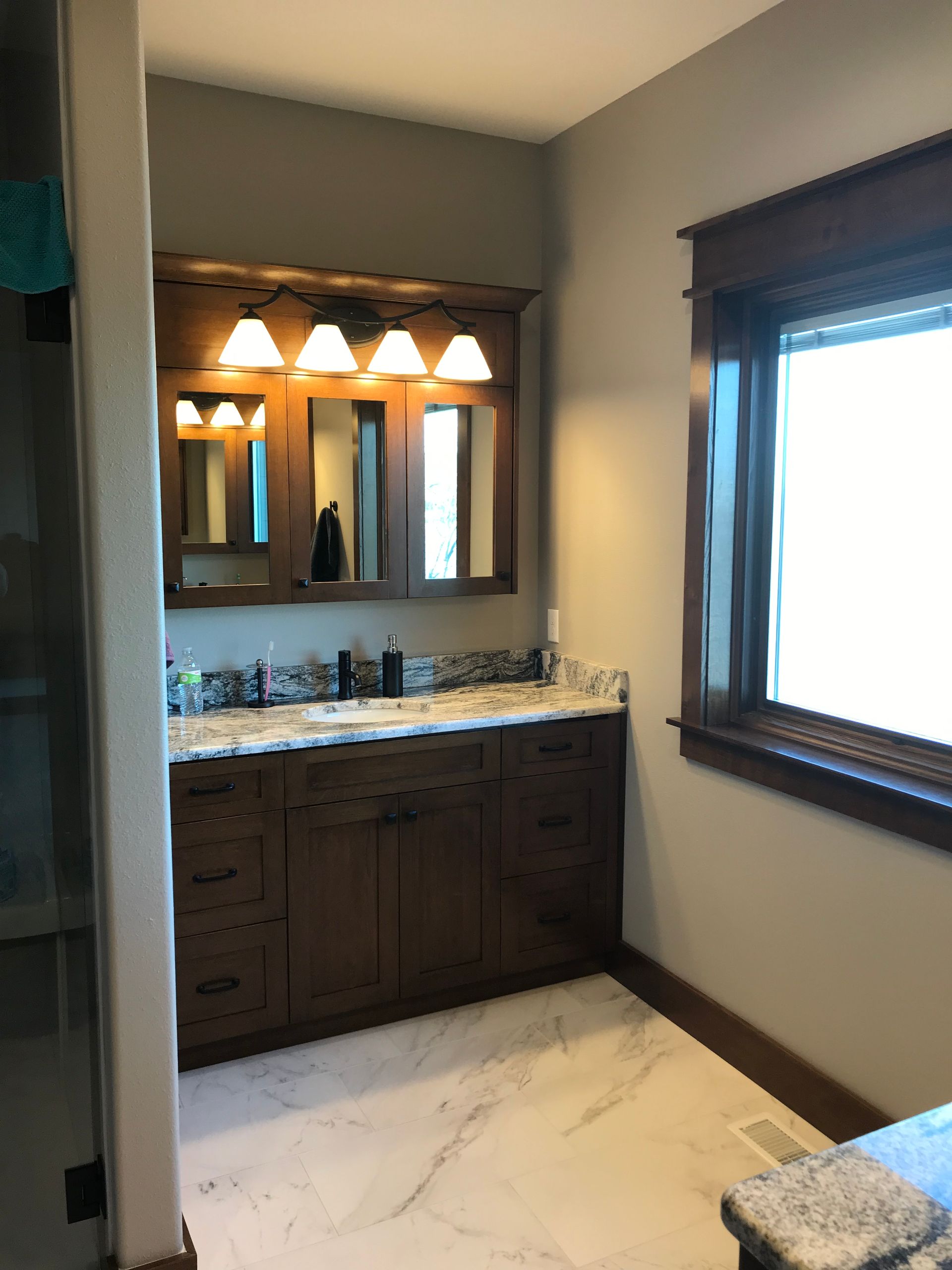 A bathroom with two sinks and a window