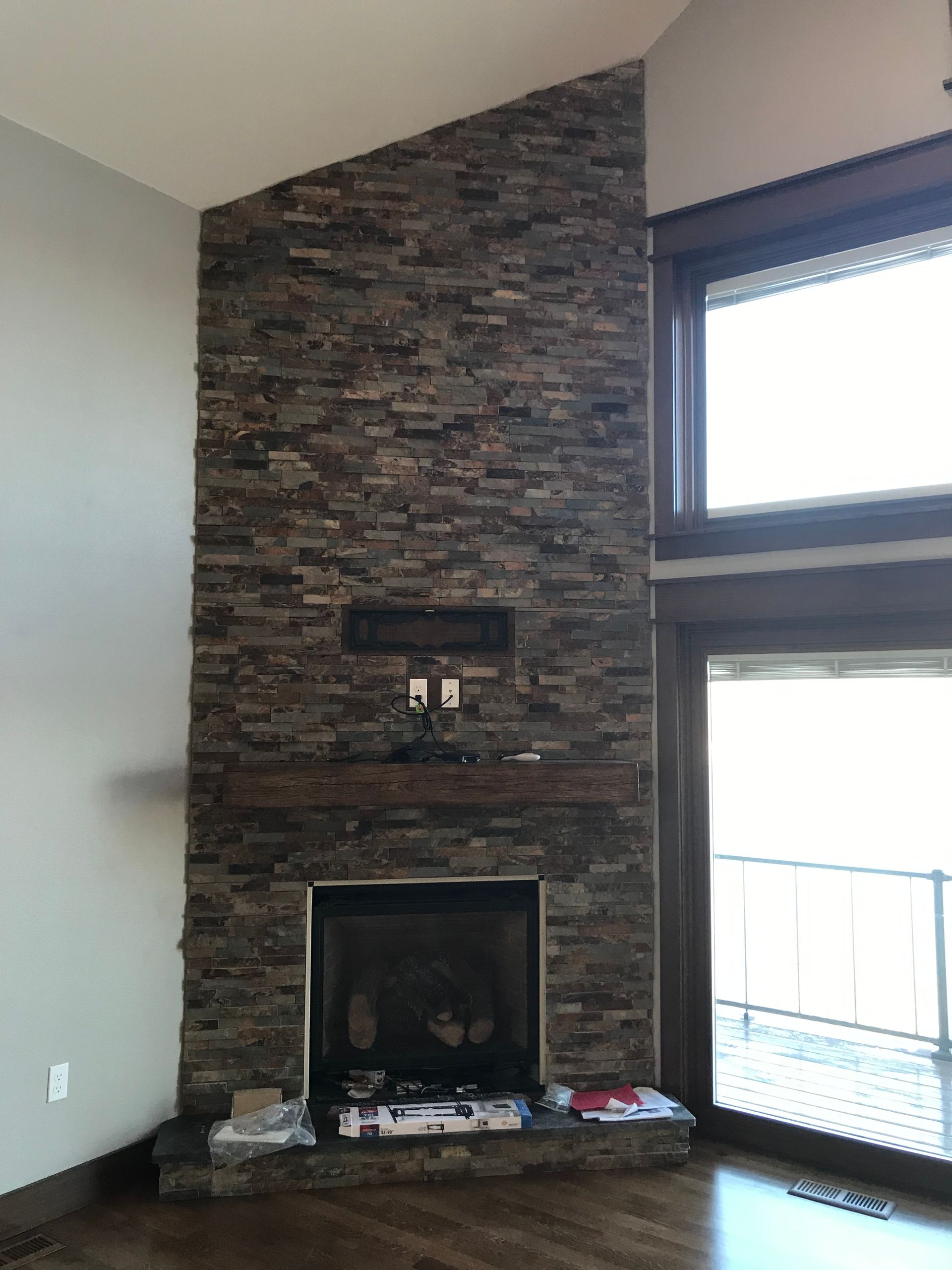 A living room with a fireplace and a large window.