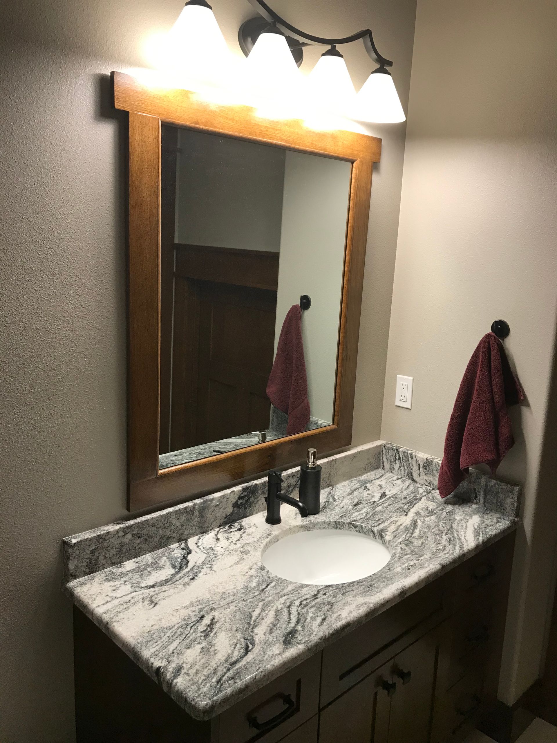 A bathroom with a sink and a mirror