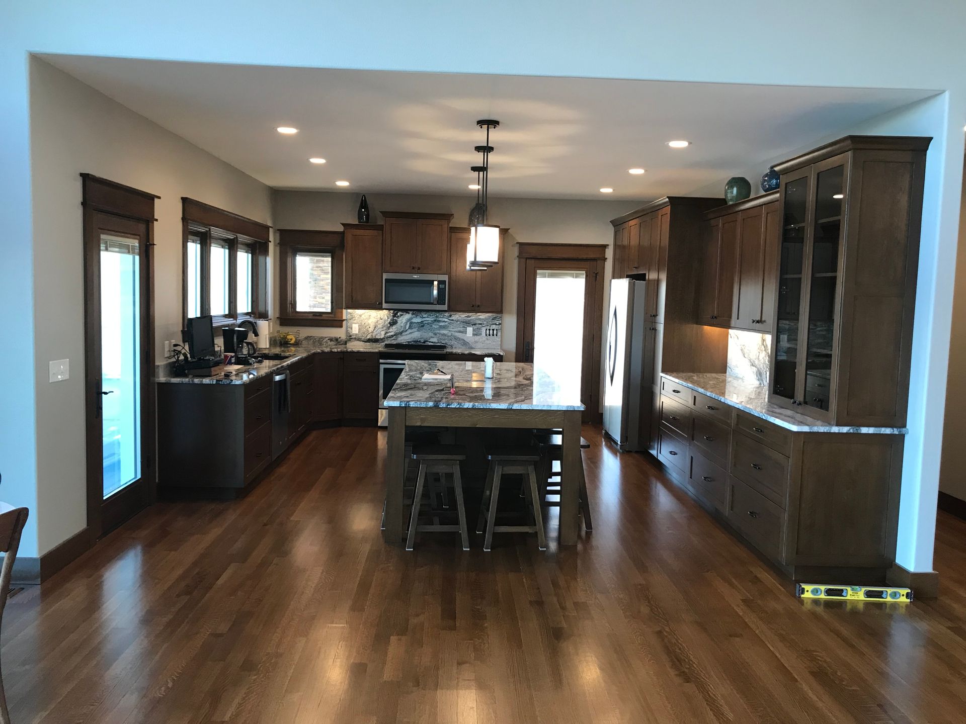 A kitchen with hardwood floors and a large island