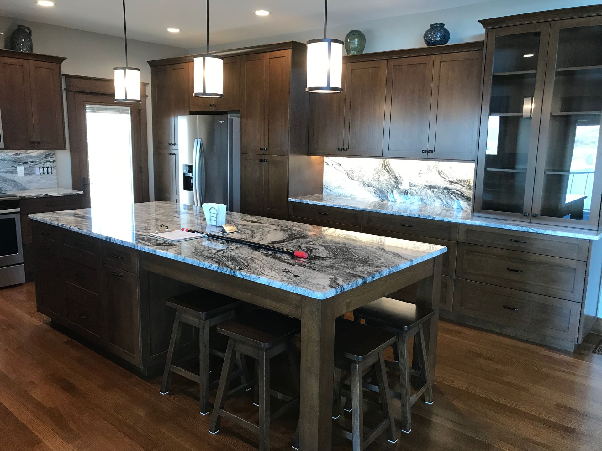 A kitchen with a large island and stools