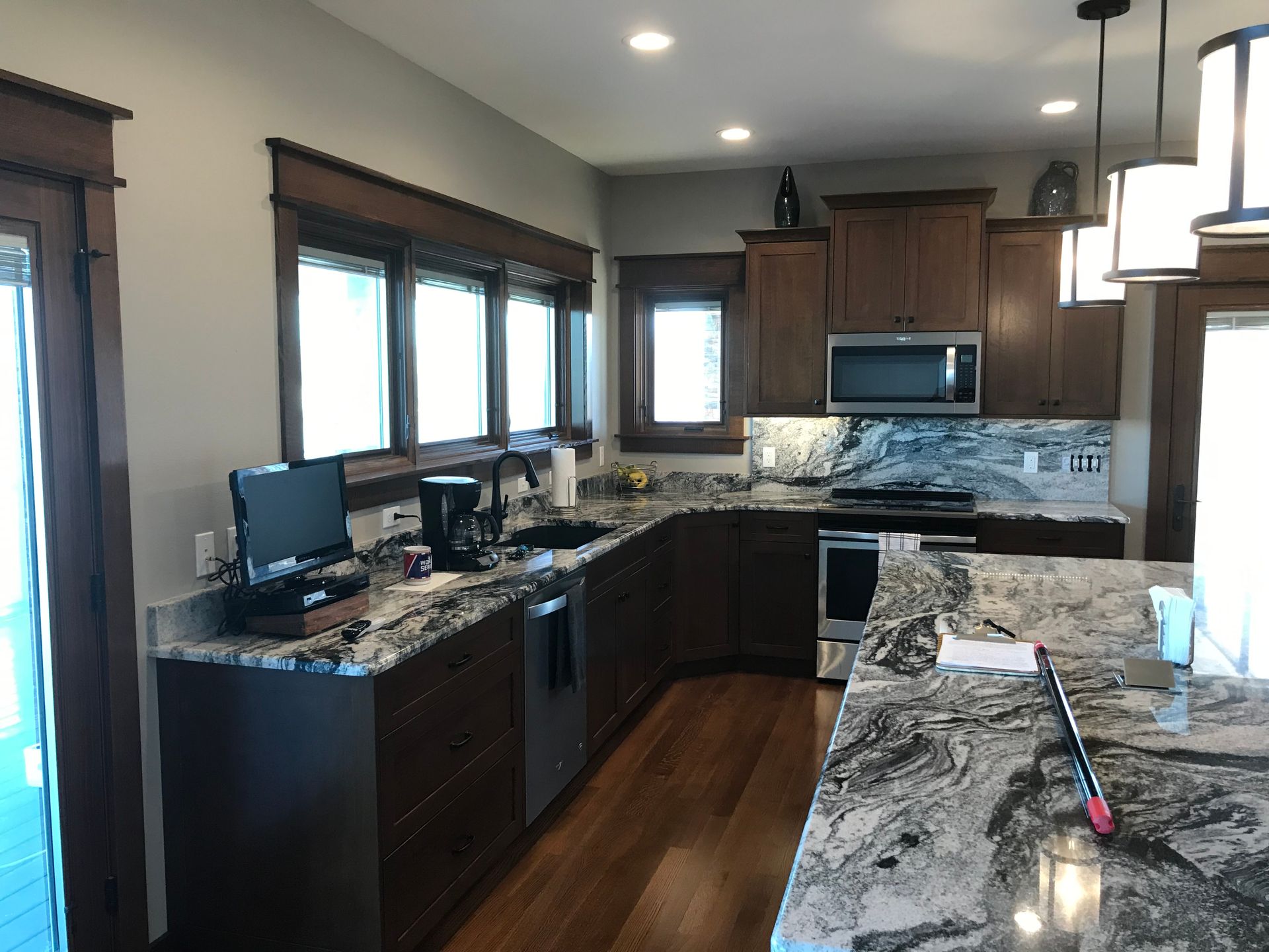 A kitchen with granite counter tops and stainless steel appliances