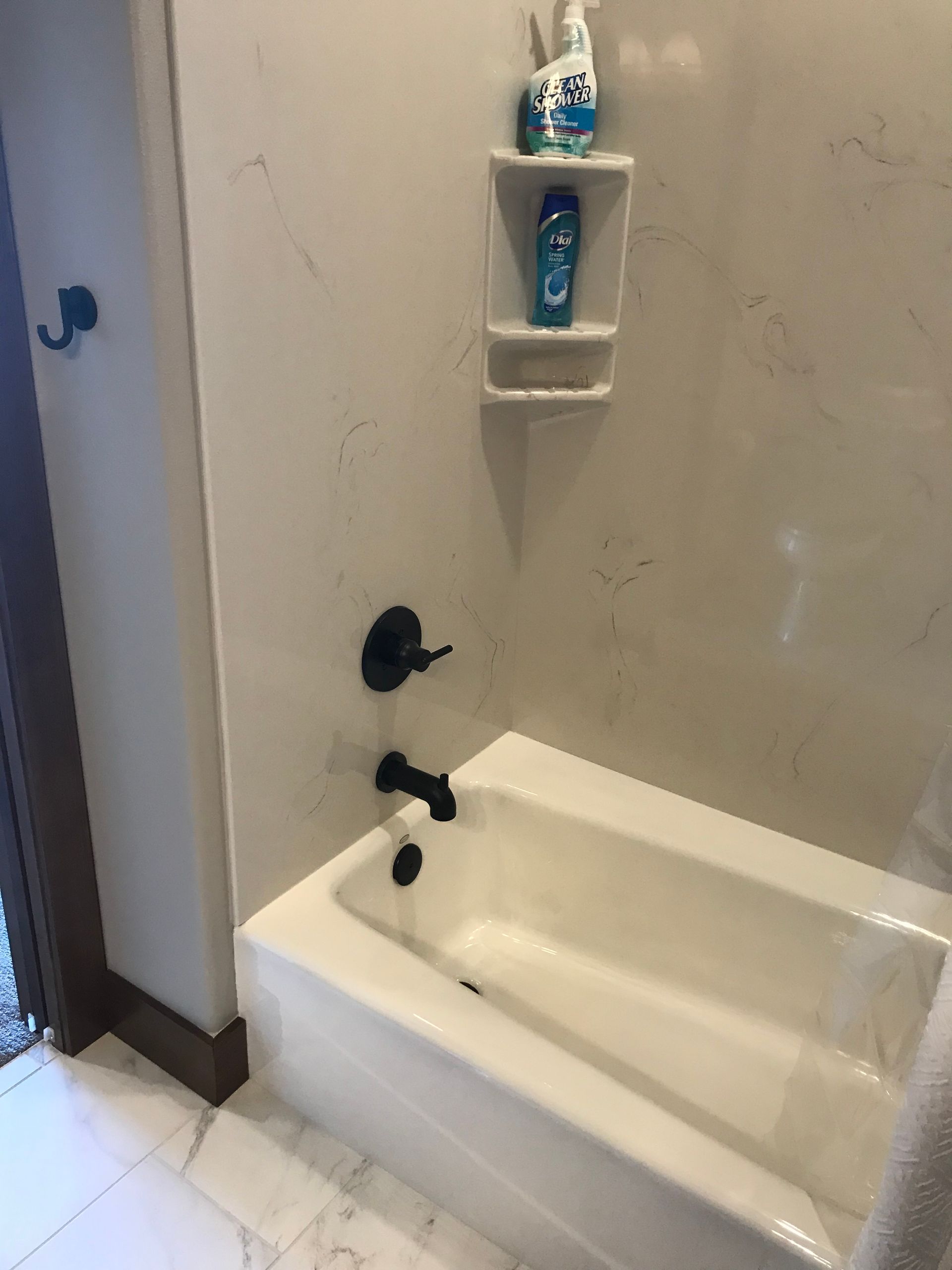 A bathroom with a bathtub and a shower.