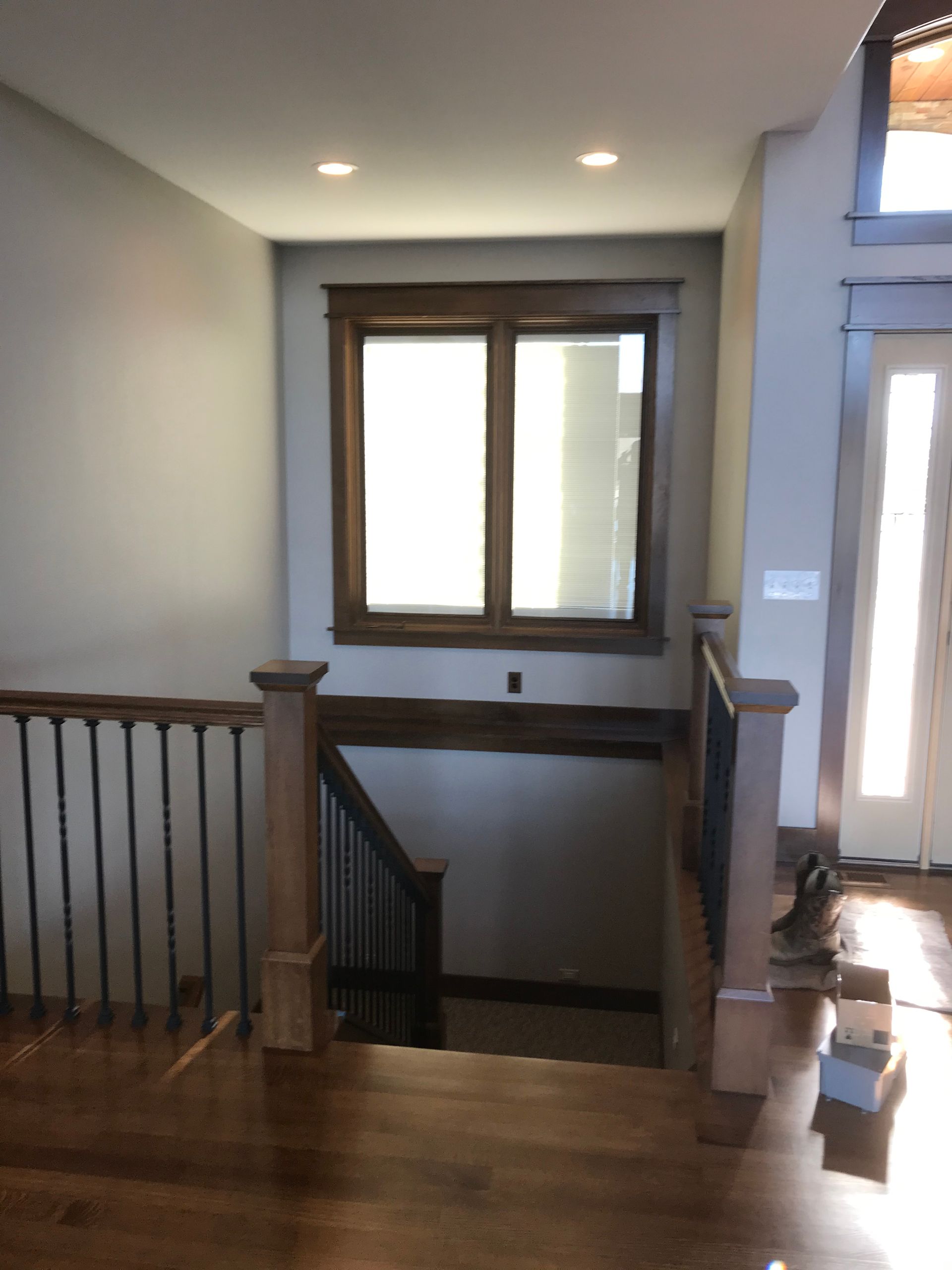 A staircase with a window and a wooden railing