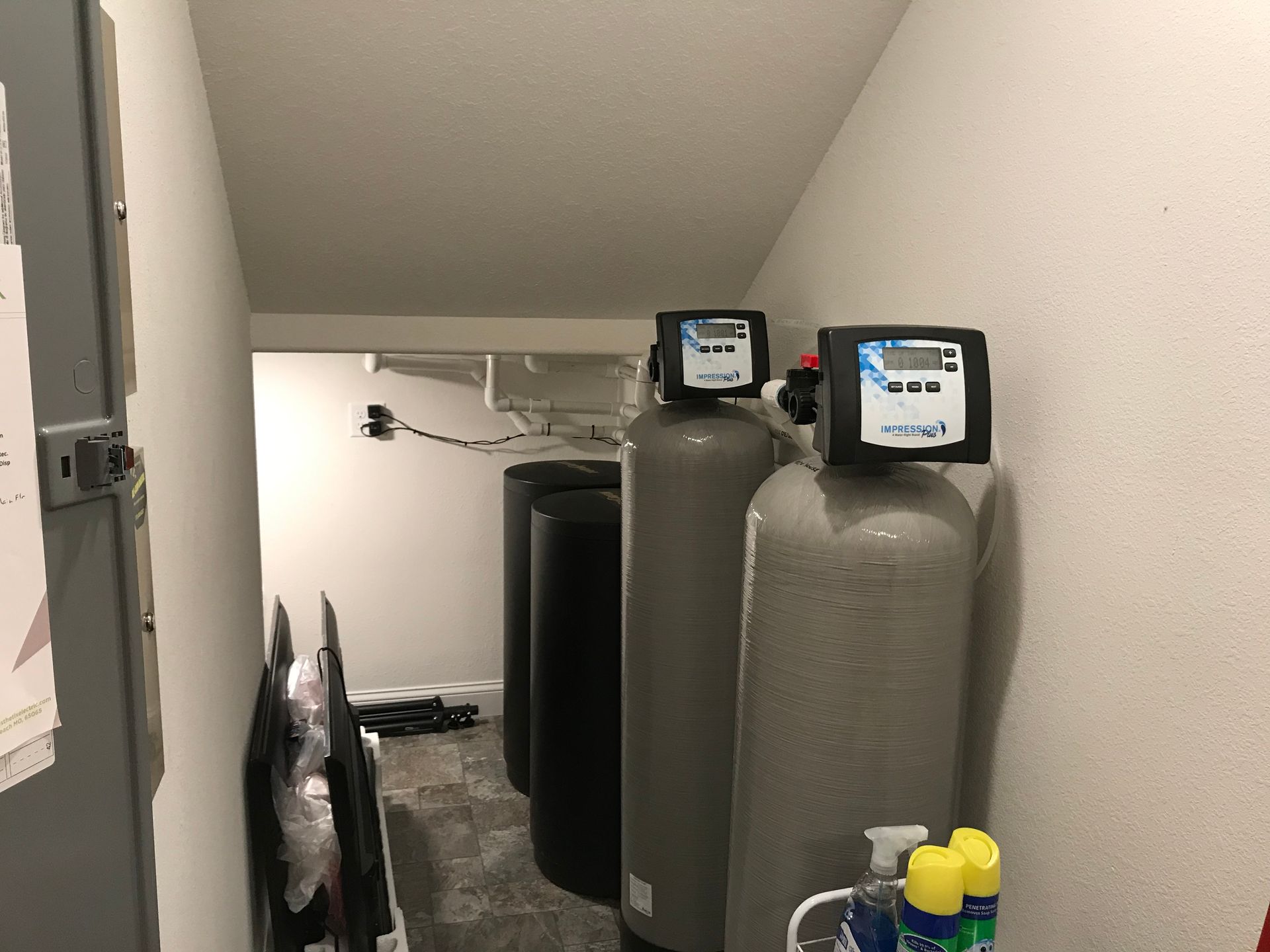 Two water filters are sitting next to each other in a room.