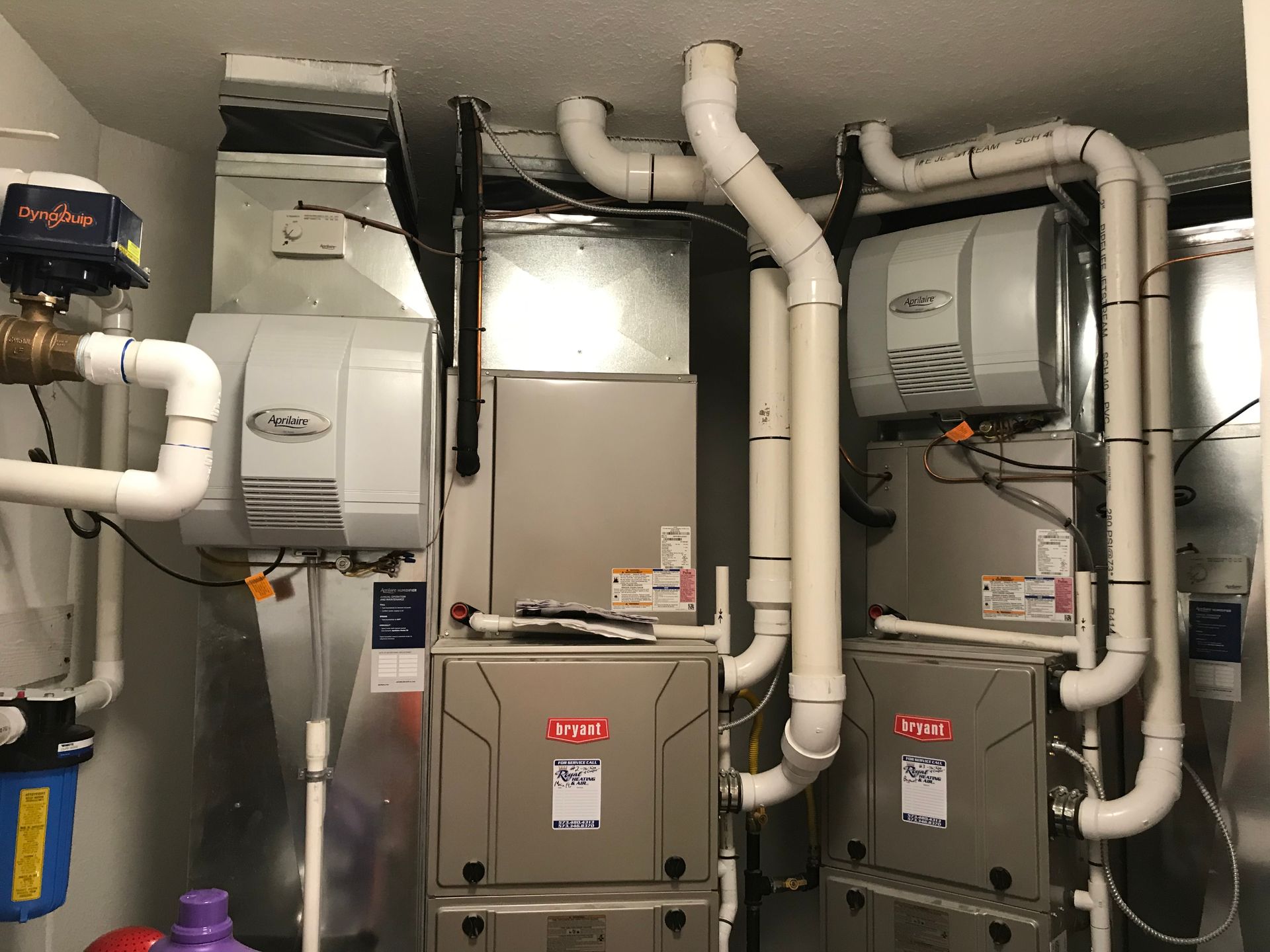 A room with a lot of pipes and appliances in it.