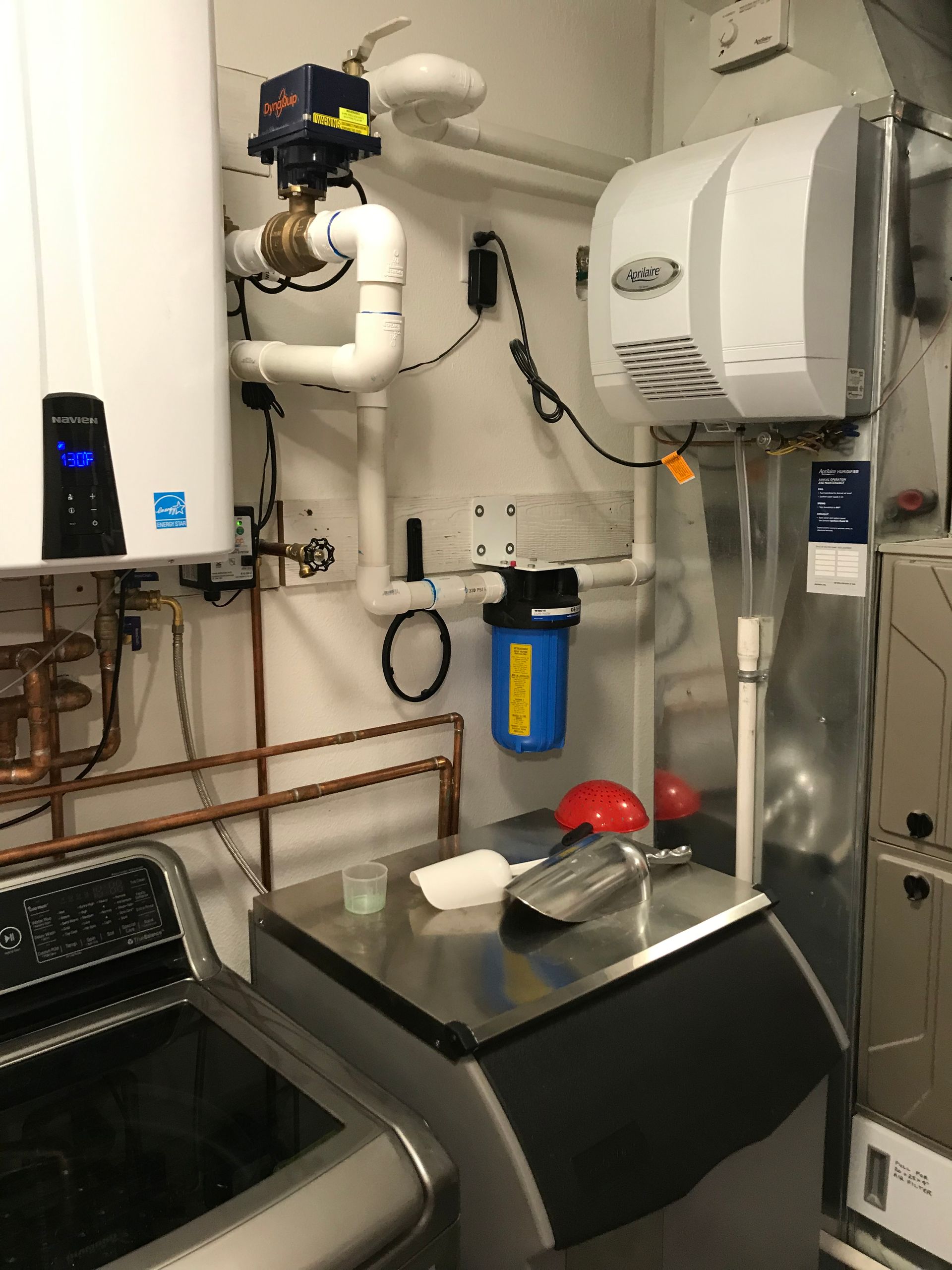A laundry room with a washer and dryer and a water heater.