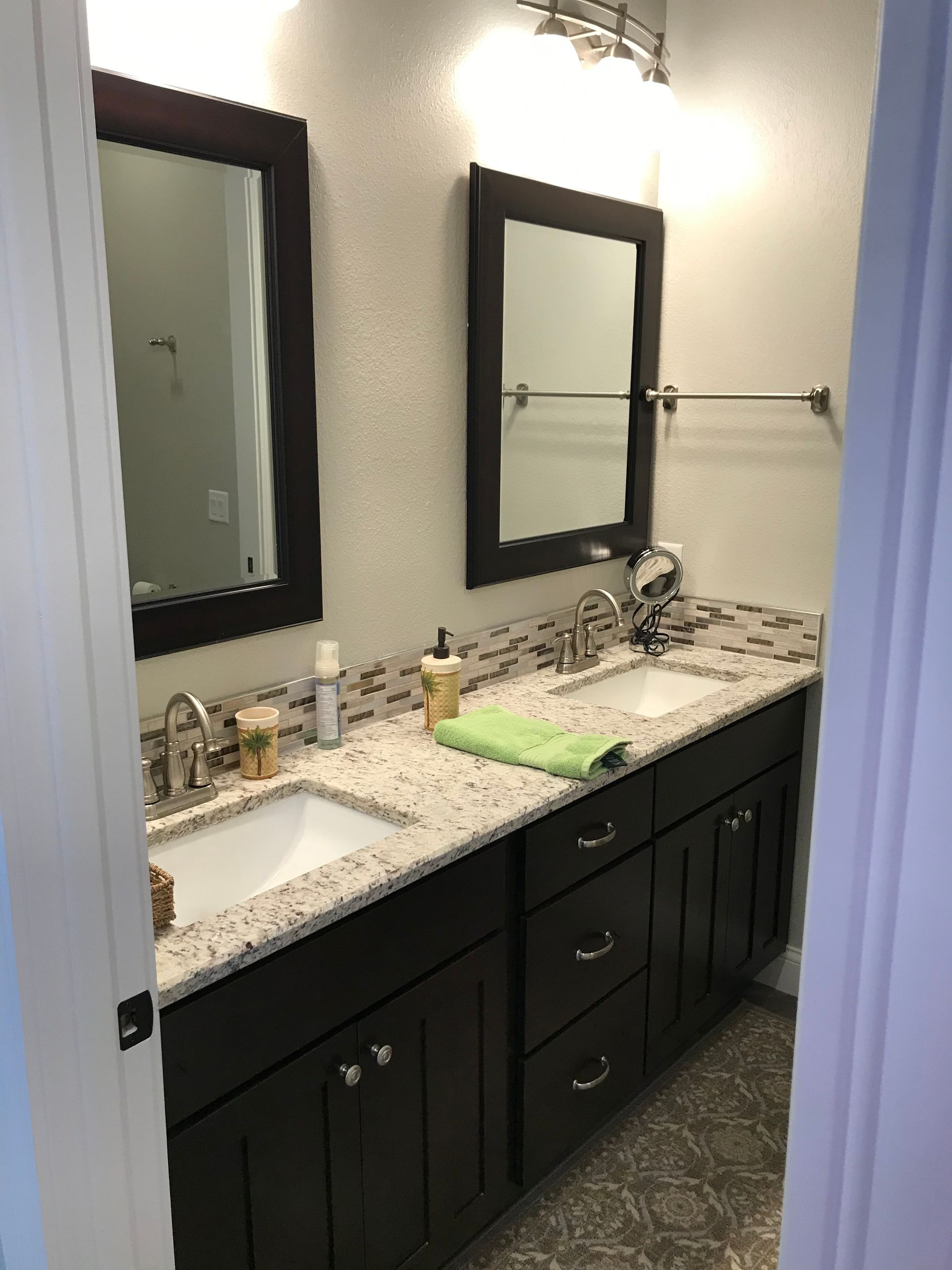 A bathroom with two sinks and two mirrors