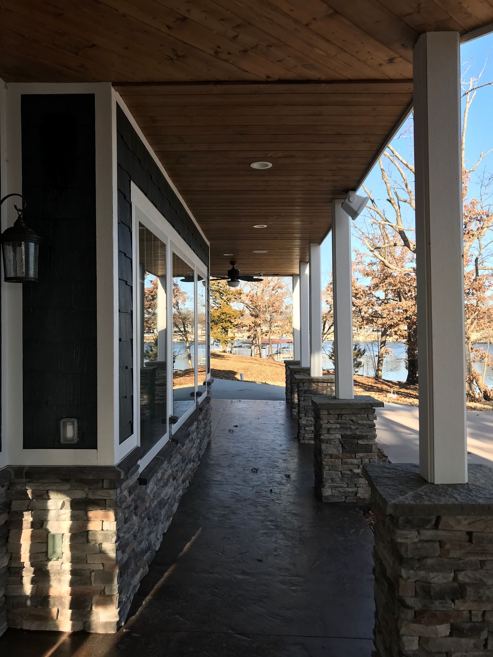 A porch with a view of a lake and trees