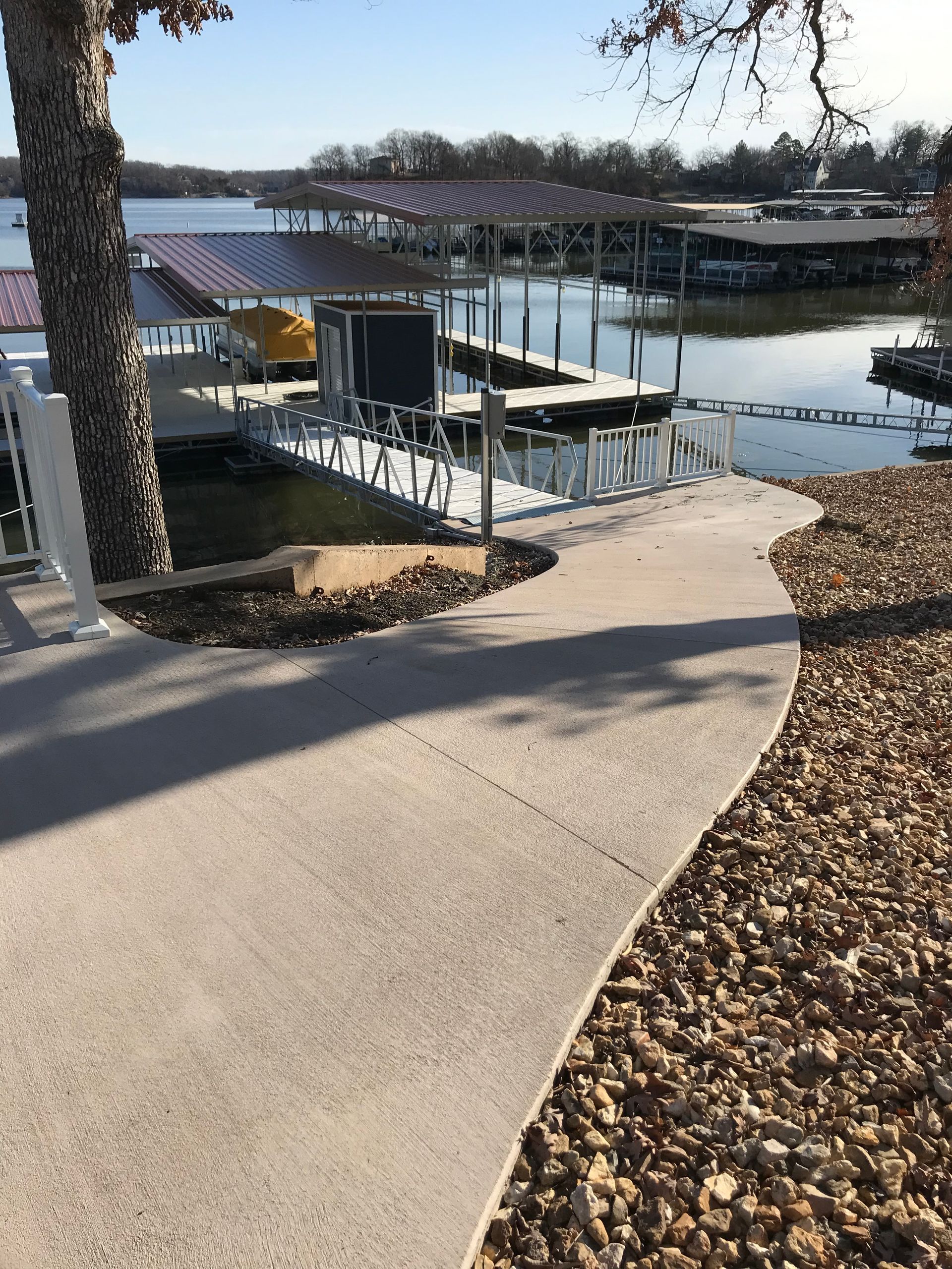 A walkway leading to a dock on a lake.