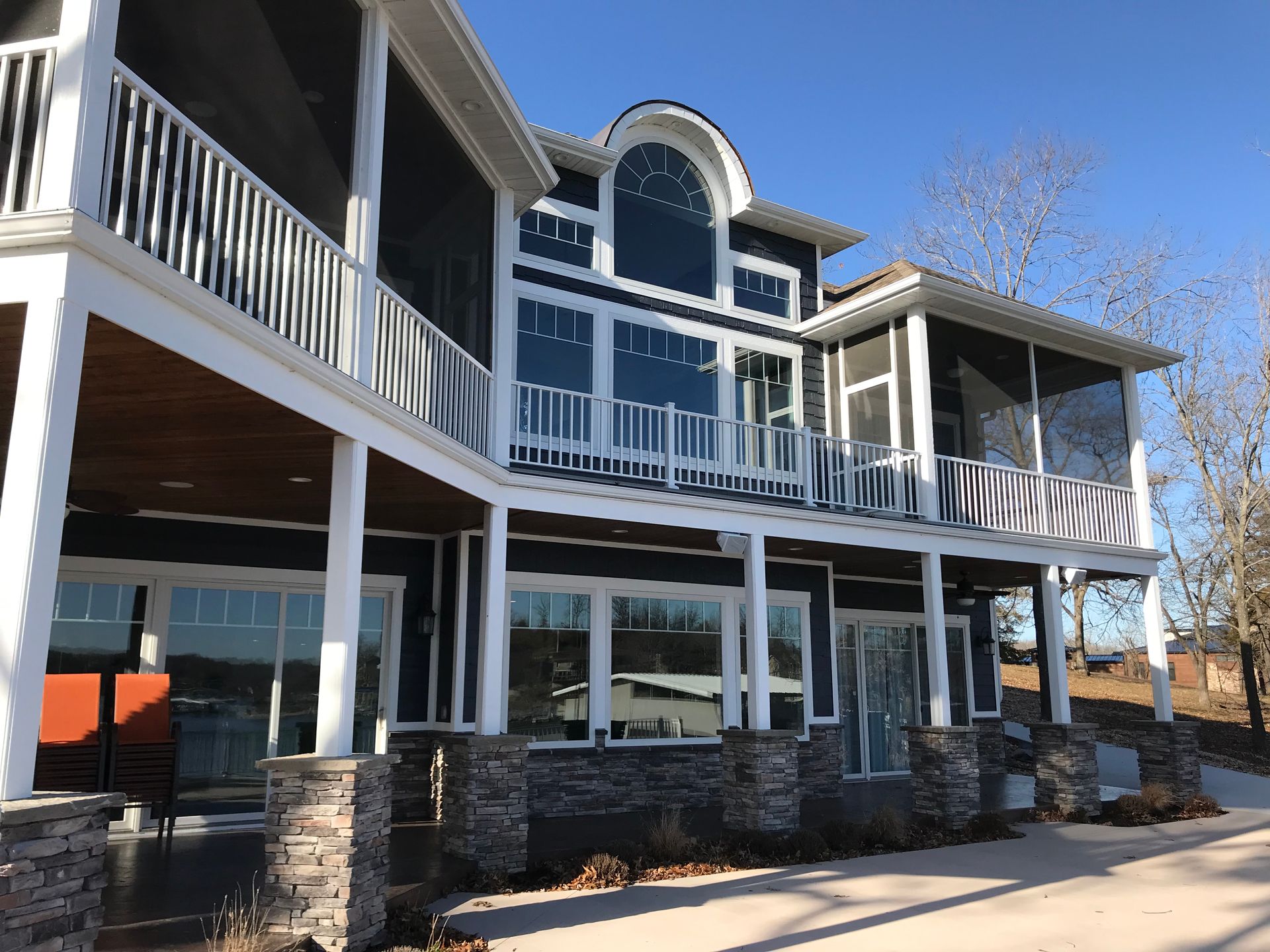 A large house with a lot of windows and a porch.