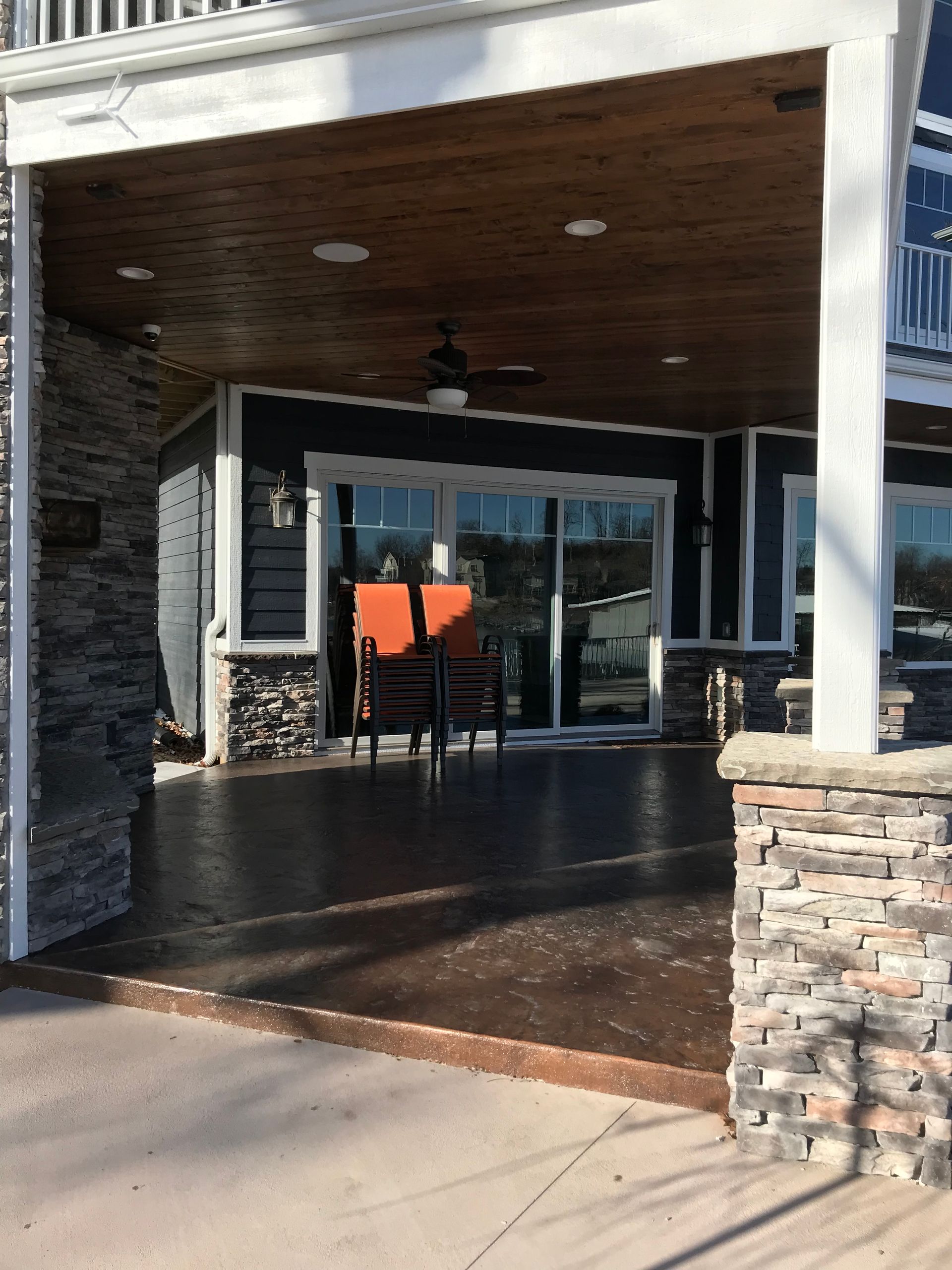 A house with a covered porch and a brick wall
