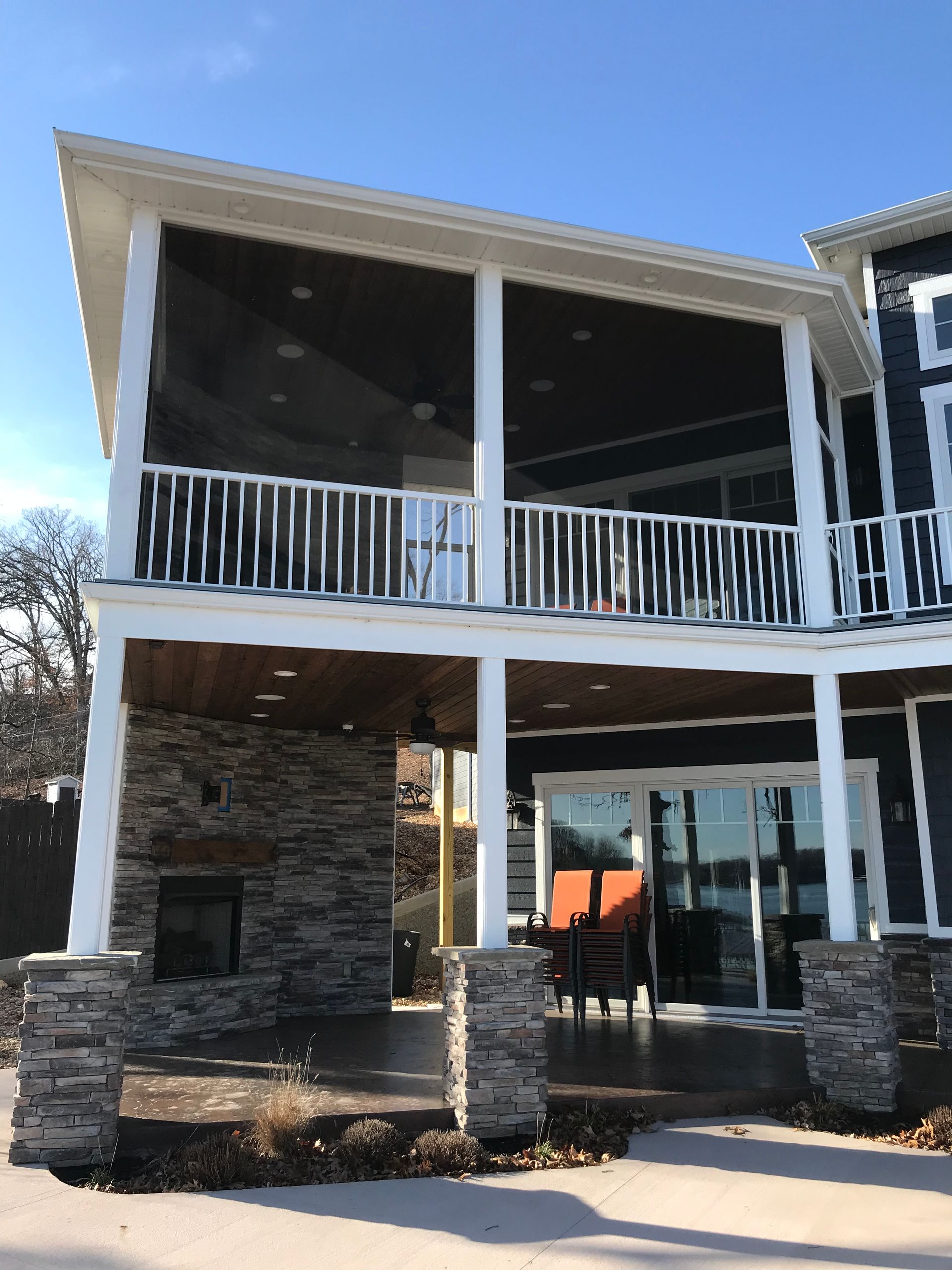 A large house with a screened in porch and a fireplace