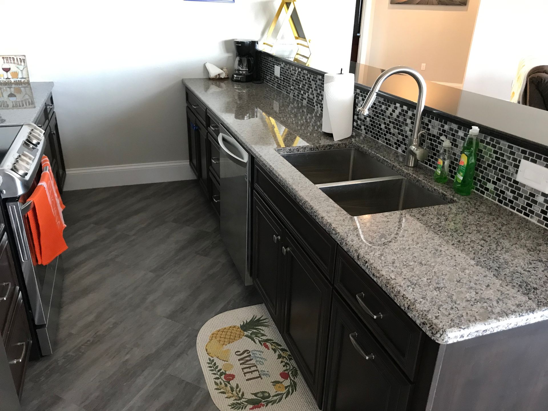 A kitchen with a sink and a rug that says spice