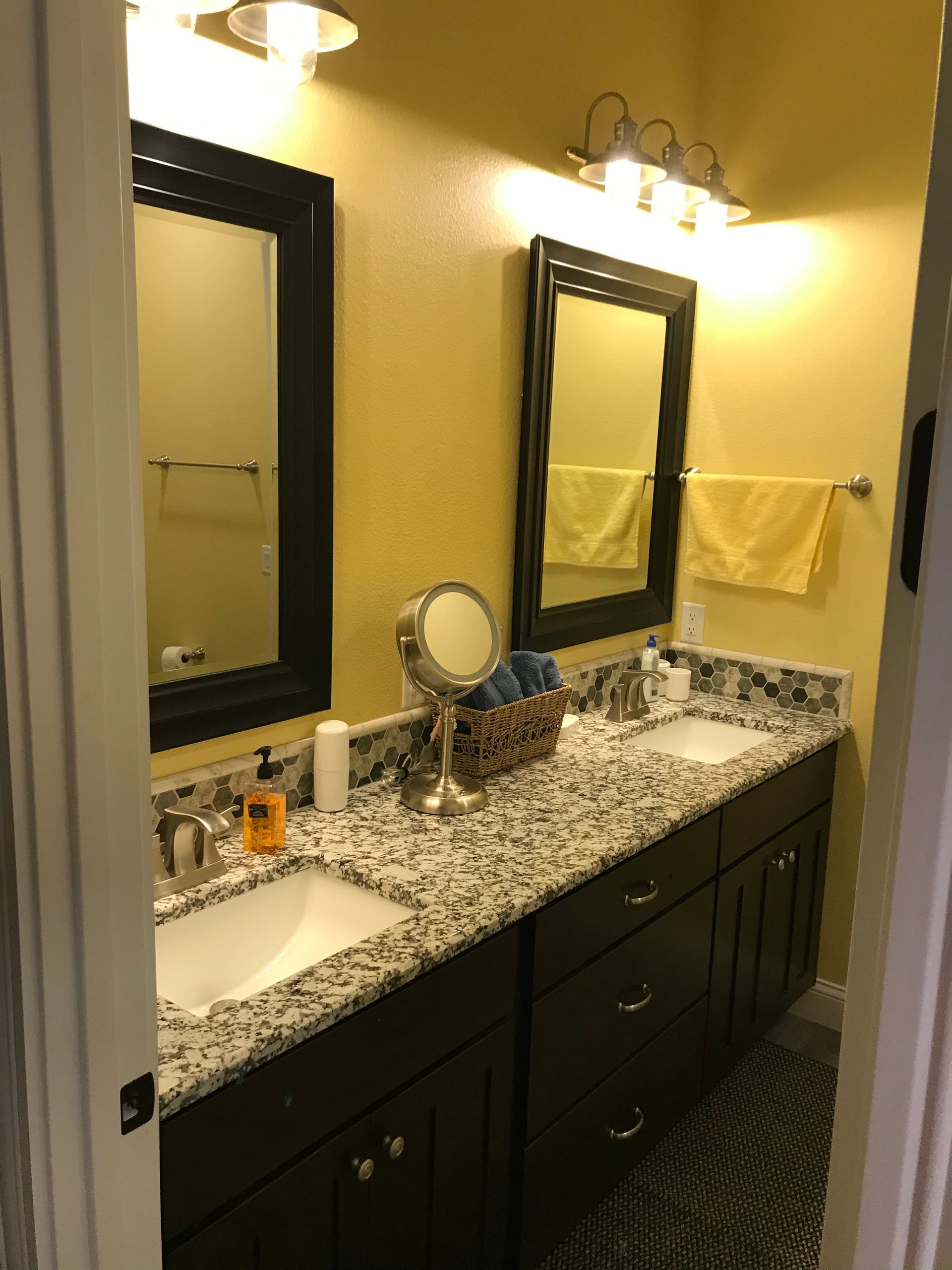 A bathroom with two sinks and two mirrors