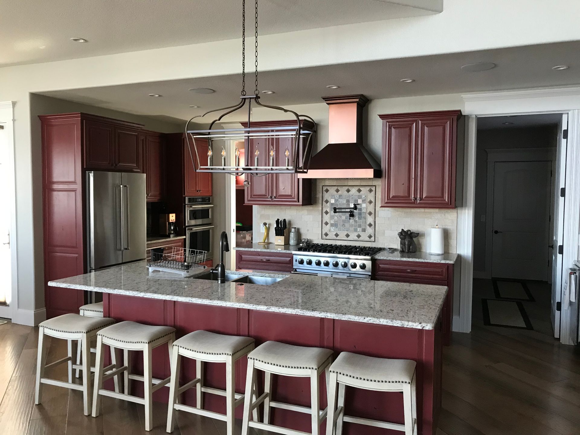 A kitchen with a large island and stools