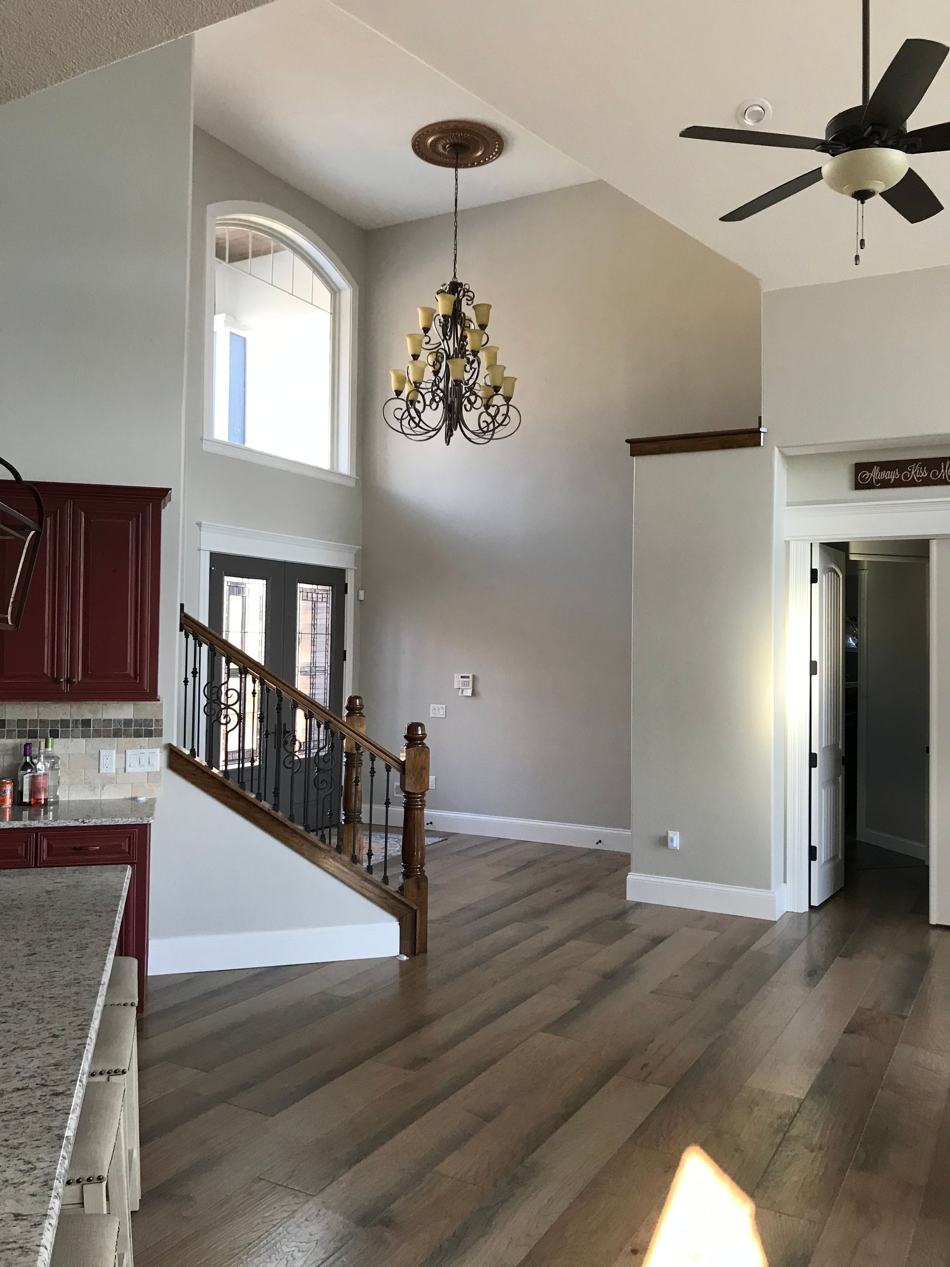 A living room with a staircase and a ceiling fan