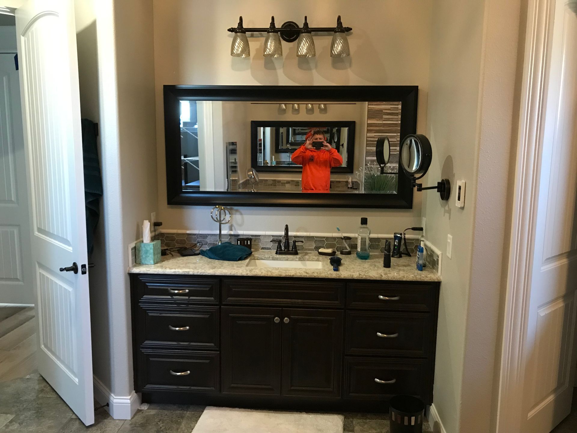 A man is taking a picture of himself in a bathroom mirror.