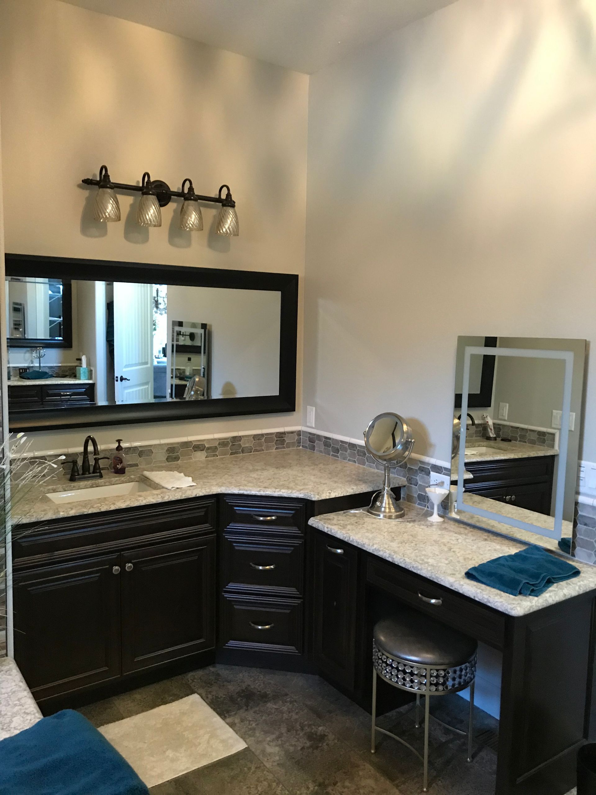 A bathroom with two sinks , a mirror and a vanity.