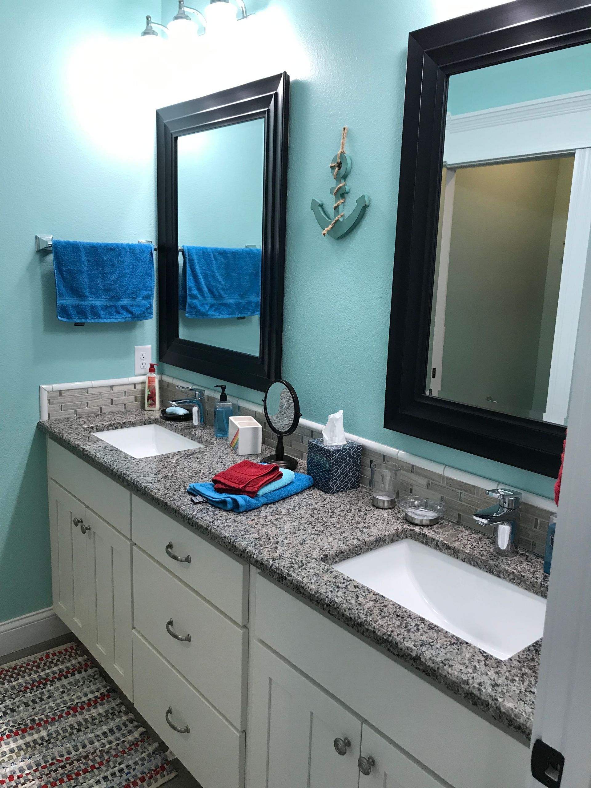 A bathroom with two sinks and two mirrors