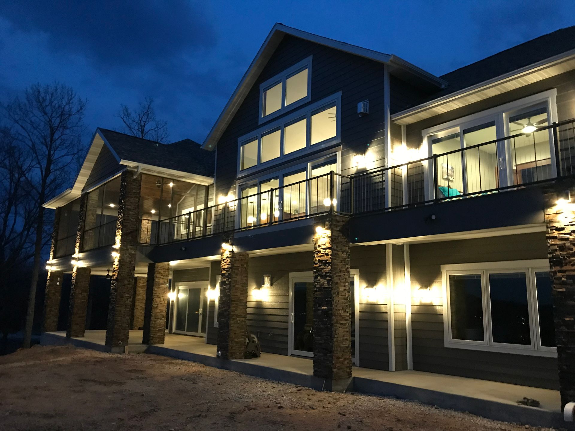 A large house with a lot of windows is lit up at night