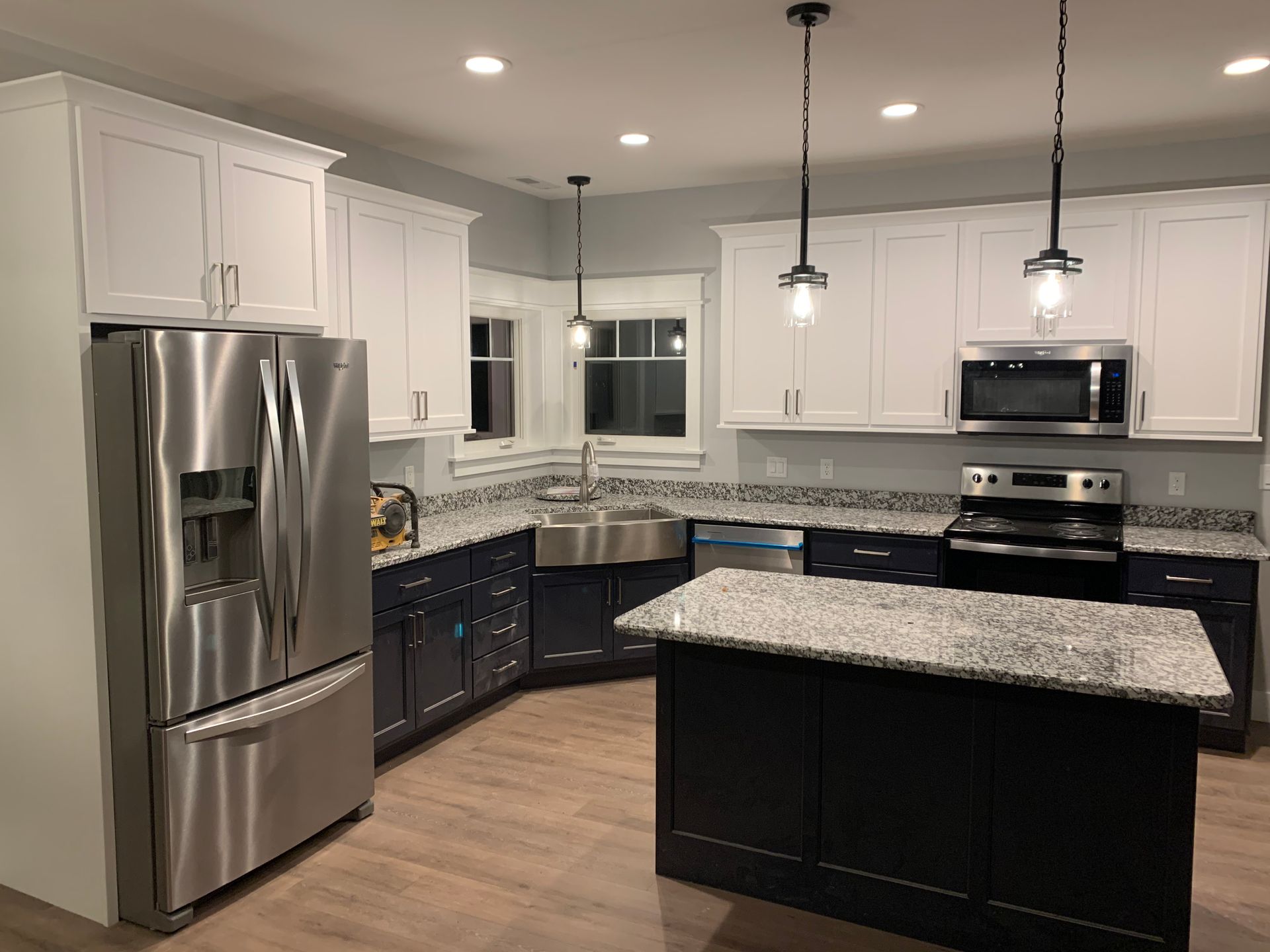 A kitchen with stainless steel appliances and granite counter tops.