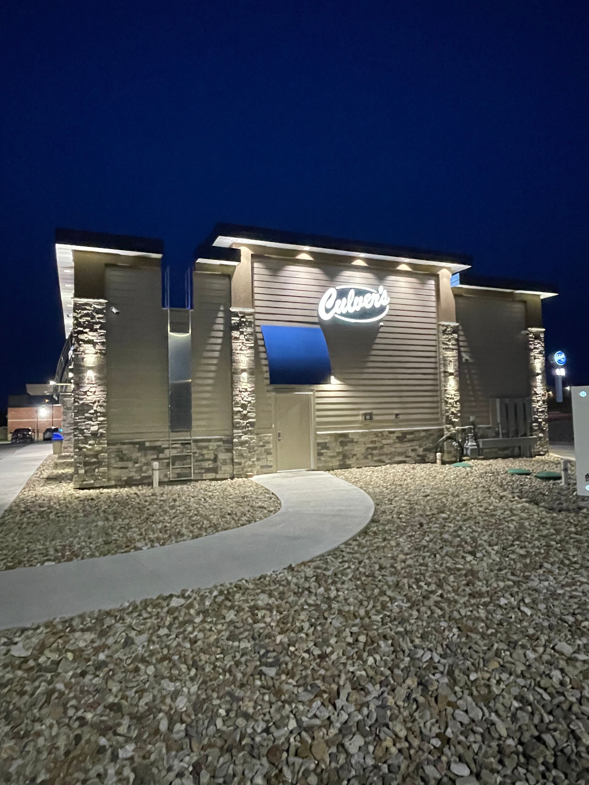 A building with a blue awning that says ' catering ' on it