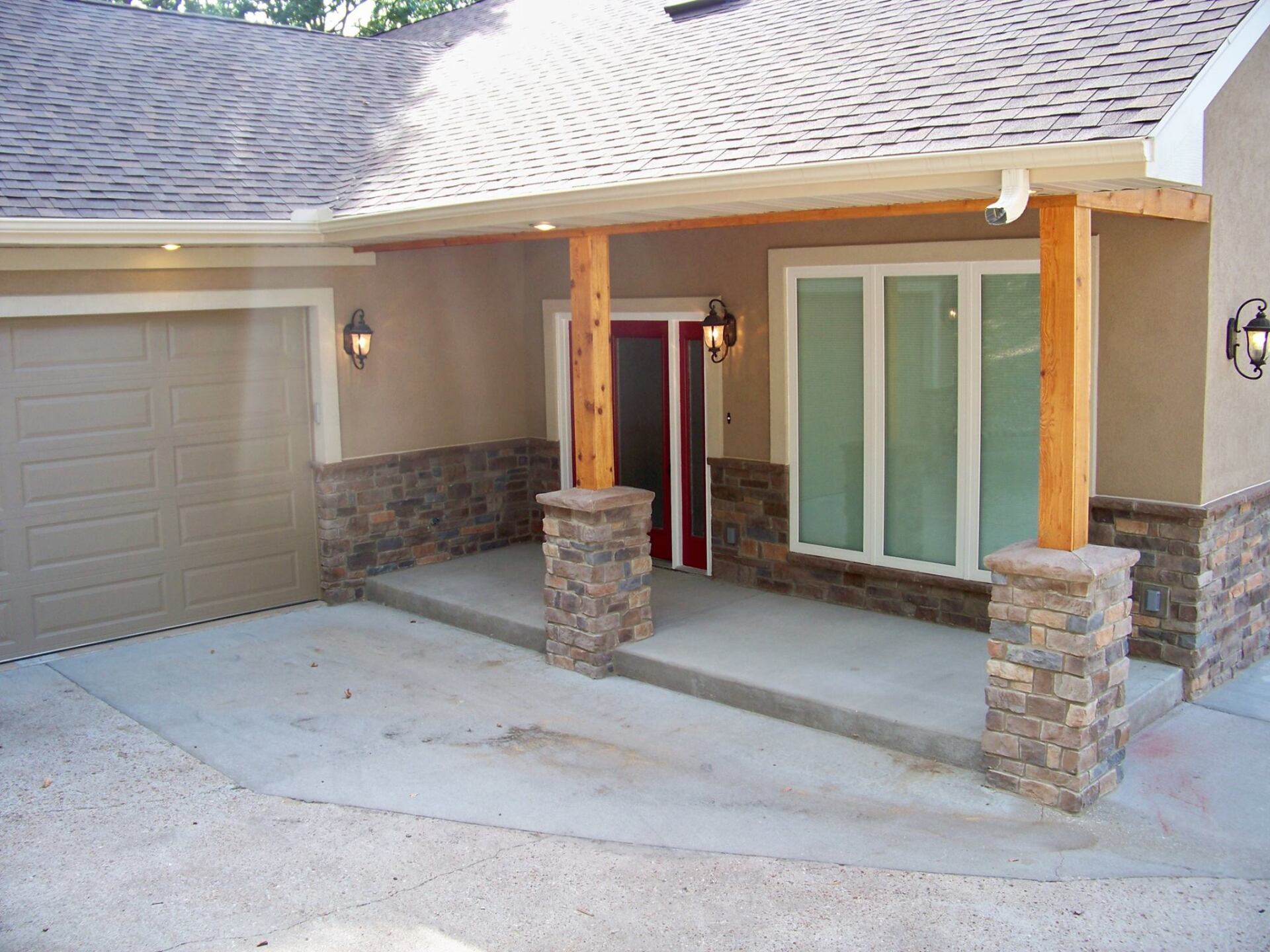 A house with a porch and a garage door