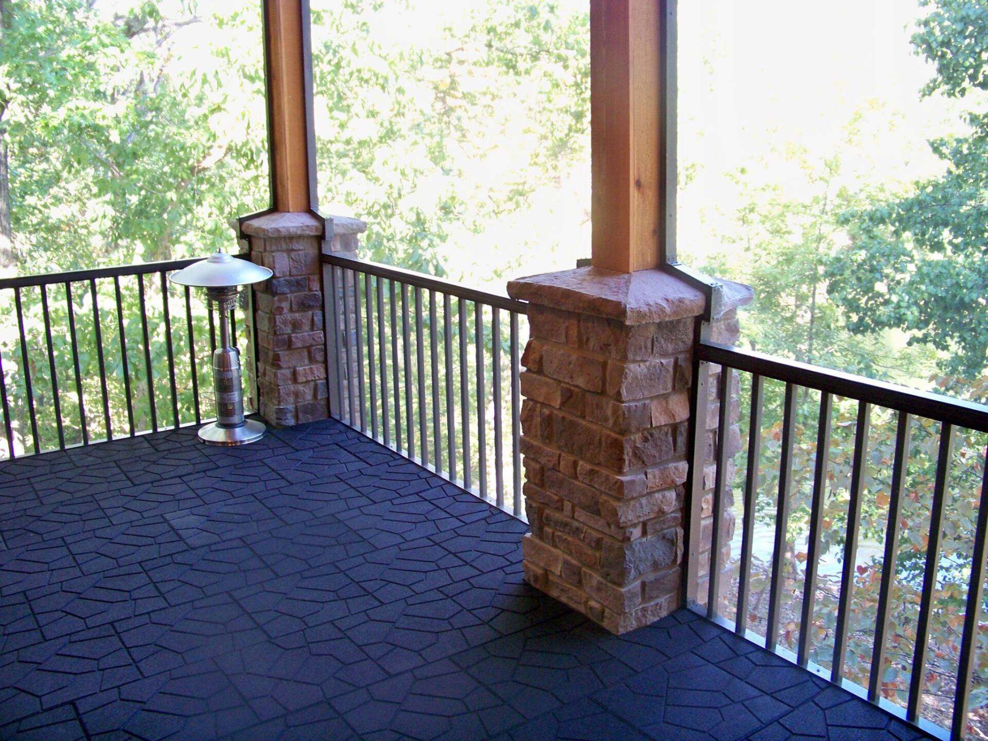 A screened in porch with a heater and a lamp